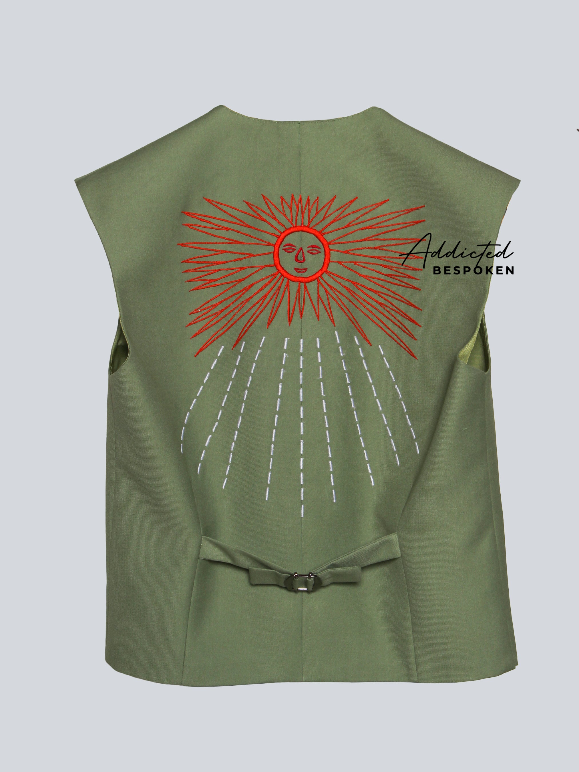 Green vest with red sun design and 'Addicted Bespoken' branding on a light gray background