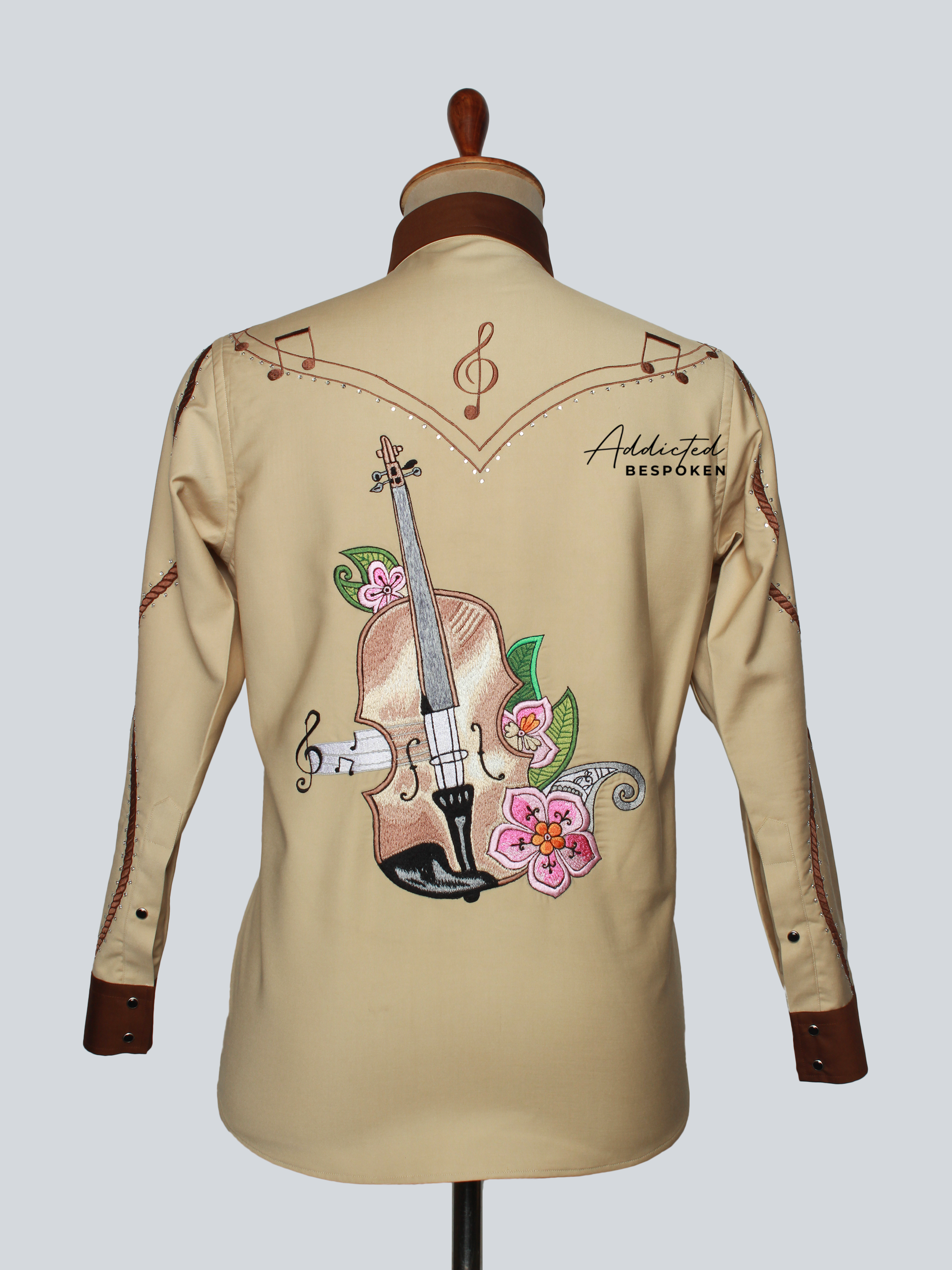 Back view of tan embroidered western shirt with musical motif and decorative stitching – Addicted Bespoken