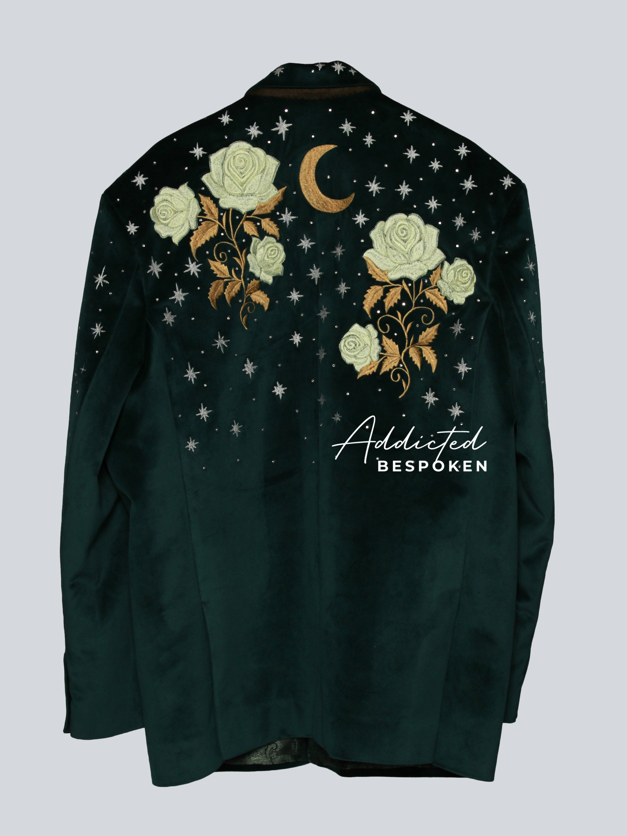 Back view of dark green embroidered blazer featuring golden flowers and celestial designs