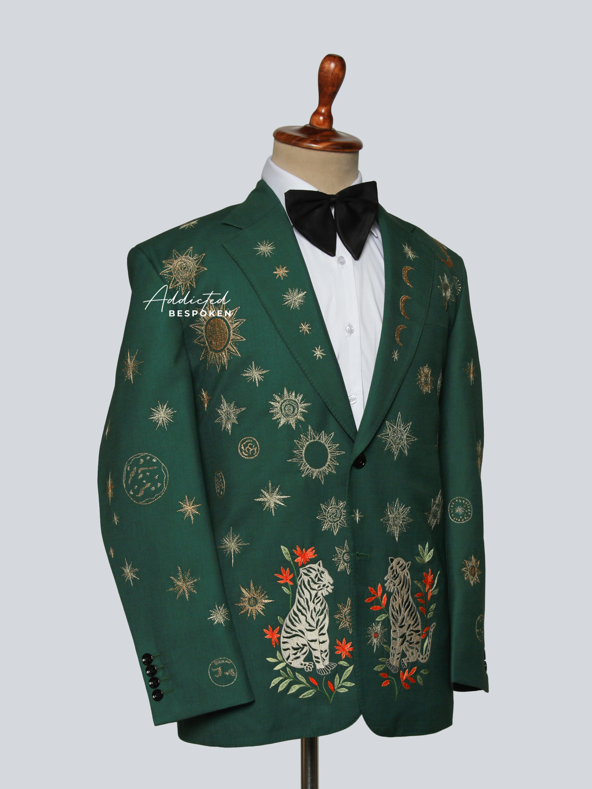 Green embroidered blazer on a mannequin with a white background
