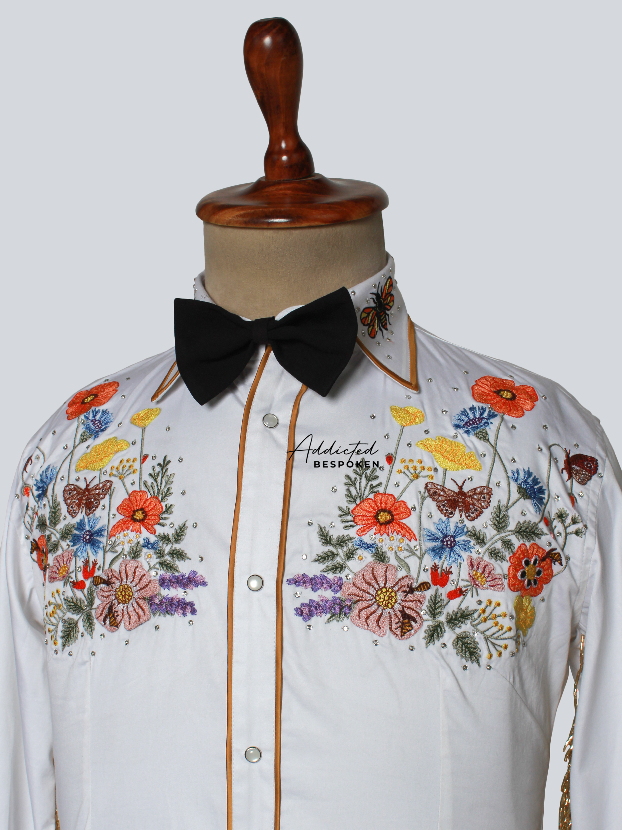 Close-up of floral embroidery on white western shirt with button-down design – Addicted Bespoken