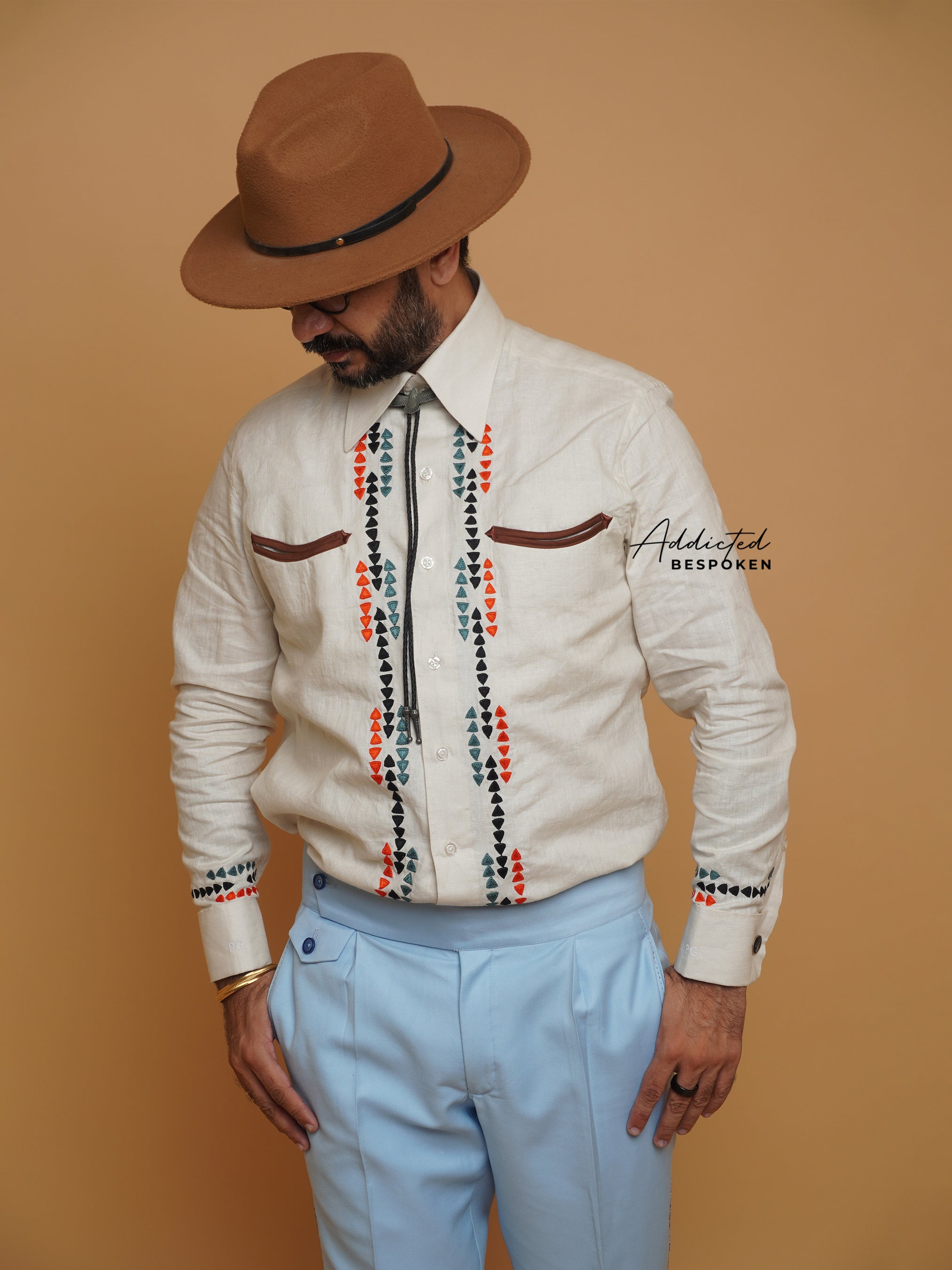 Front view of male model wearing cream embroidered western shirt with red and black detailing β Addicted Bespoken