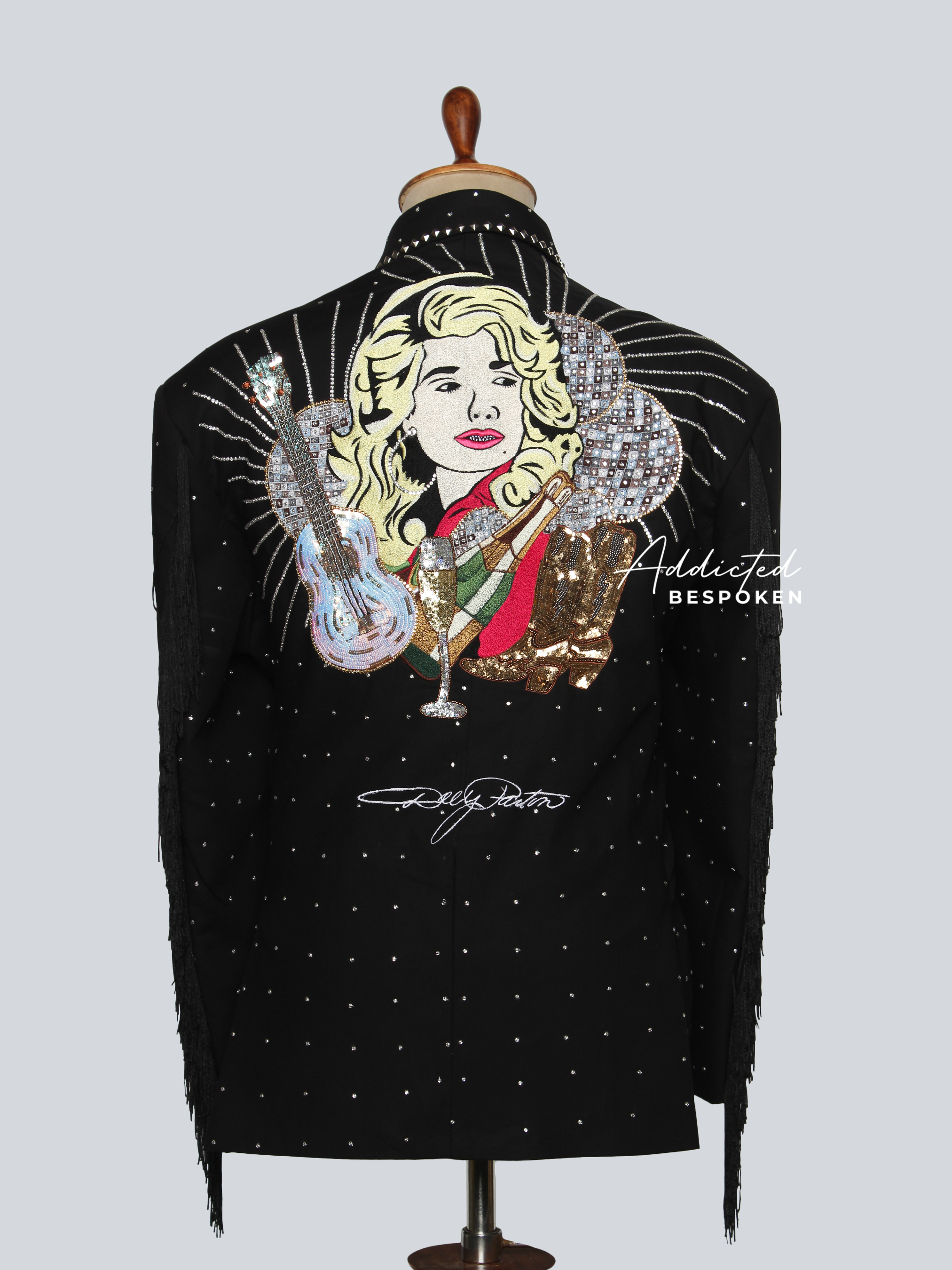 Black jacket with artistic design and 'Addicted' branding on a mannequin against a light gray background.