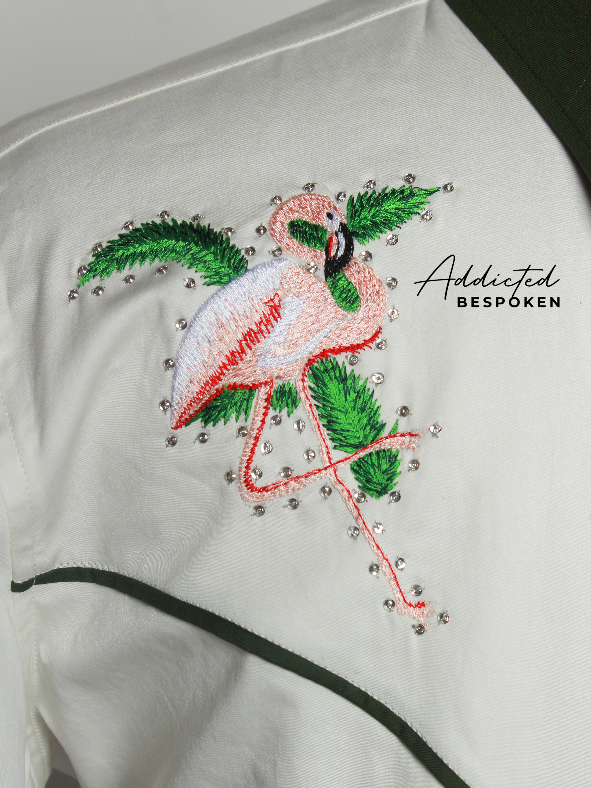 Close-up of detailed pink floral embroidery on white western shirt โ Addicted Bespoken