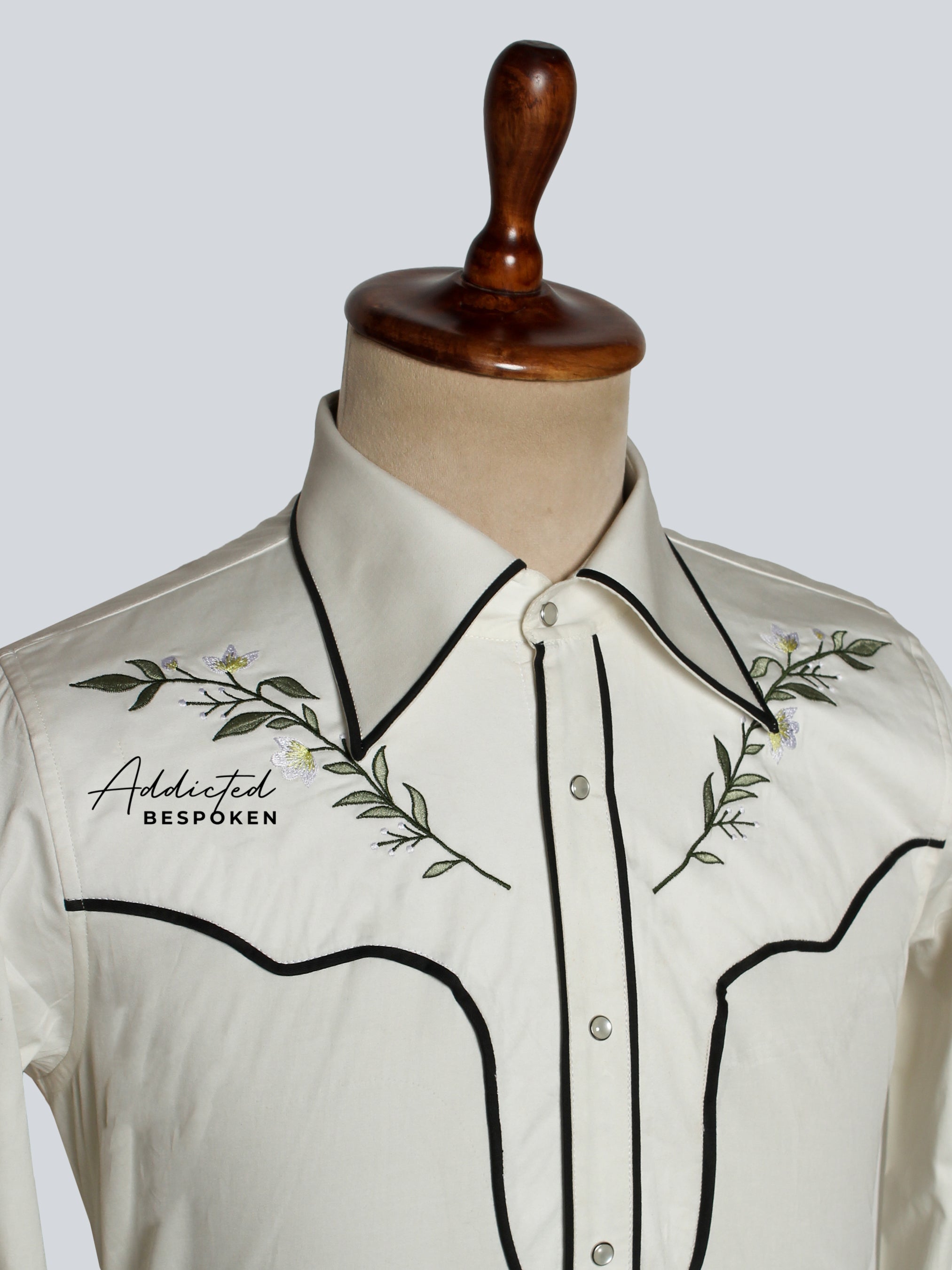 Close-up of embroidered chest design on white western shirt with black piping – Addicted Bespoken