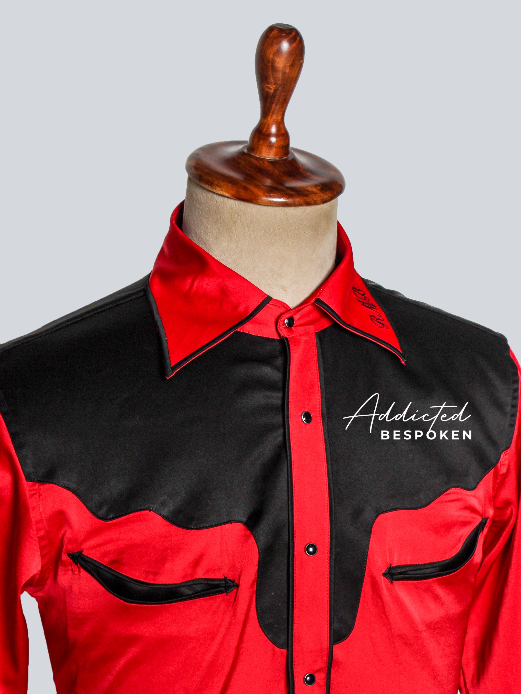 Close-up chest view of red shirt with black yoke and embroidered logo – Addicted Bespoken