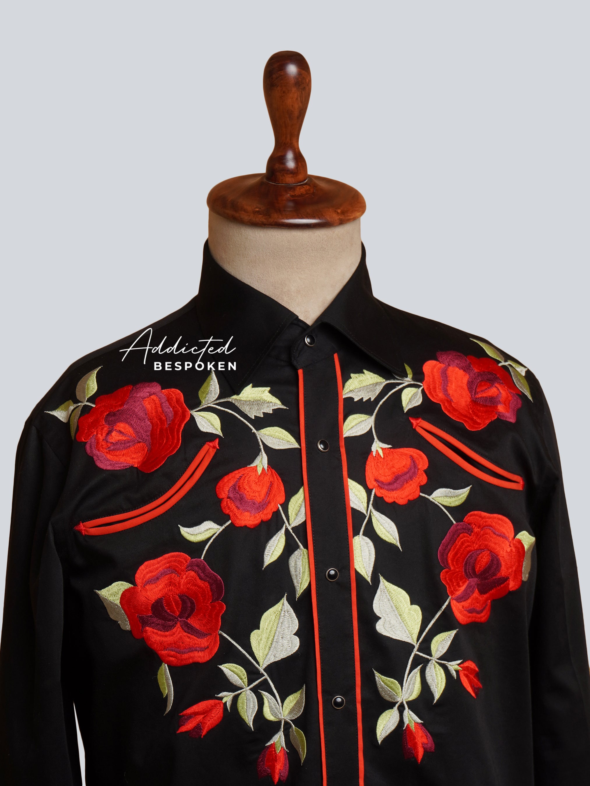 Close-up chest view of black shirt with detailed red floral embroidery β Addicted Bespoken