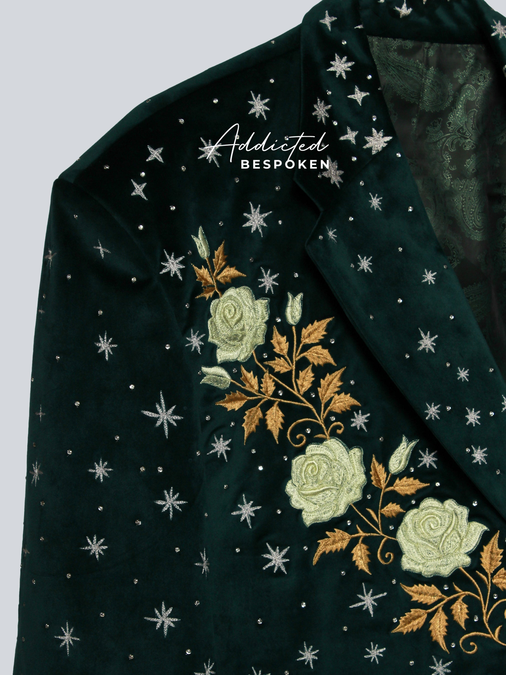 Dark green blazer with floral embroidery and star patterns – angled side view