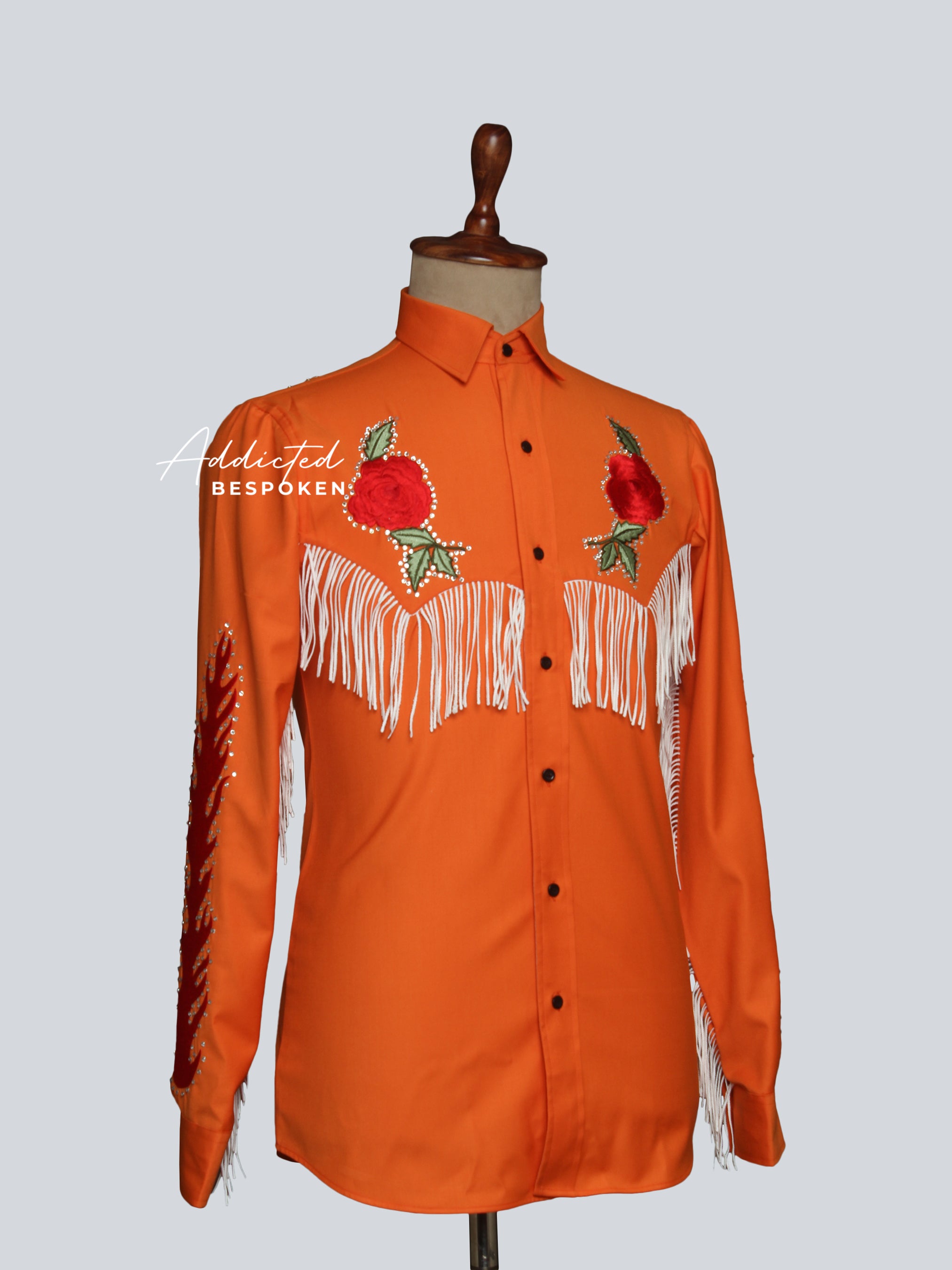 Side angled view of orange western shirt with floral embroidery and fringe โ Addicted Bespoken