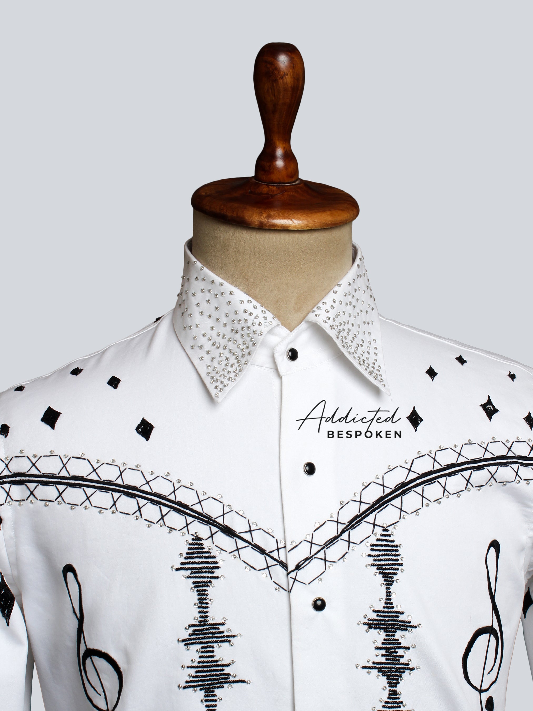 Close-up chest view of white shirt with black embroidered star and line motifs โ Addicted Bespoken