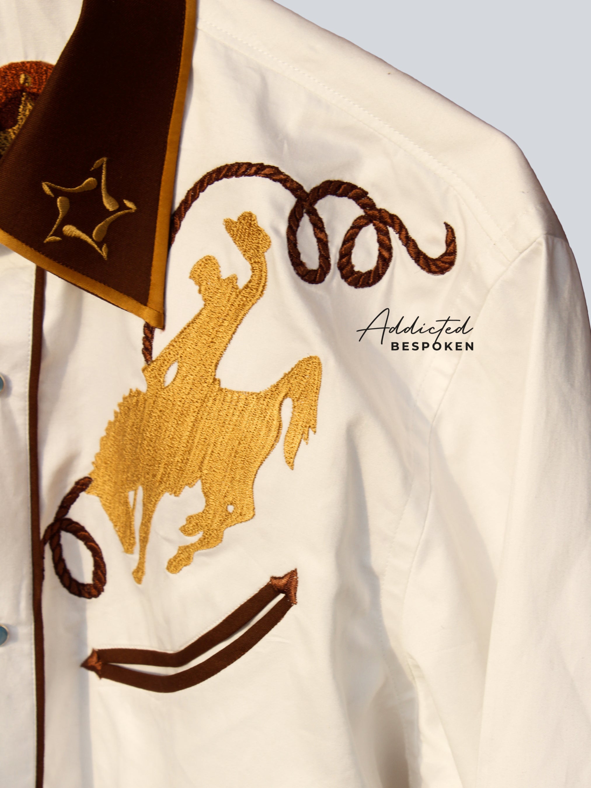 Close-up chest embroidery of horse and rope design on cream western shirt β Addicted Bespoken