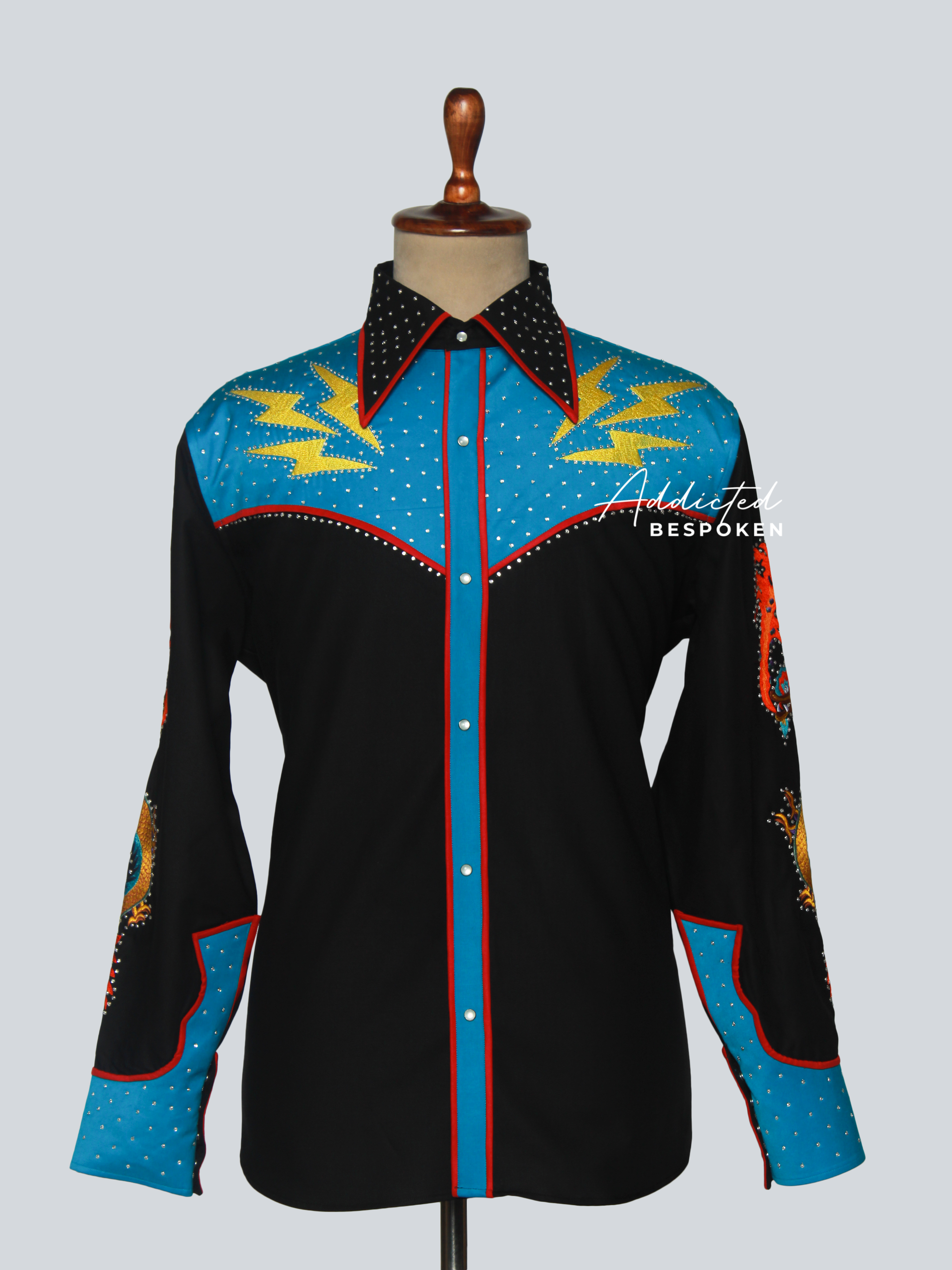Front view of black western shirt with bright blue yoke, yellow embroidery, and red piping – Addicted Bespoken
