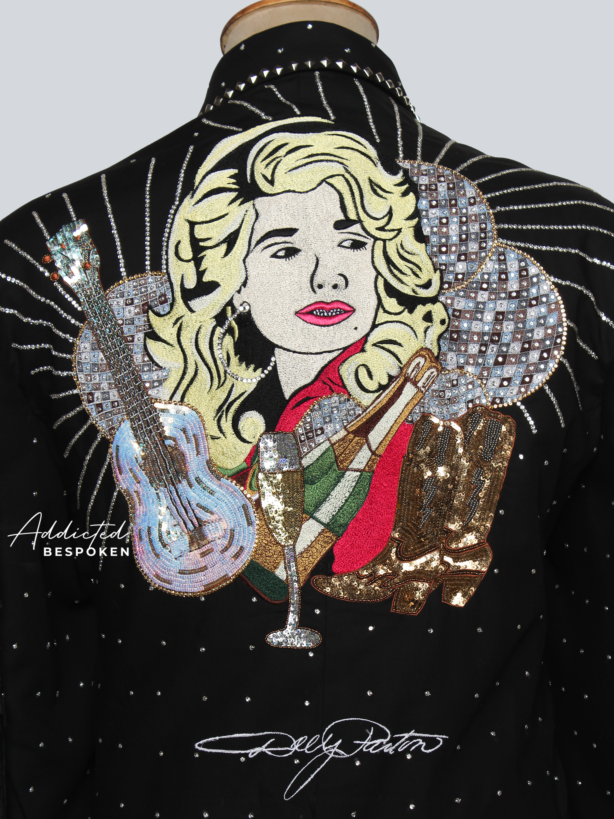 Embroidered jacket with a decorative design of a woman holding a glass and a snake, with 'Addicted Bespoke' branding.