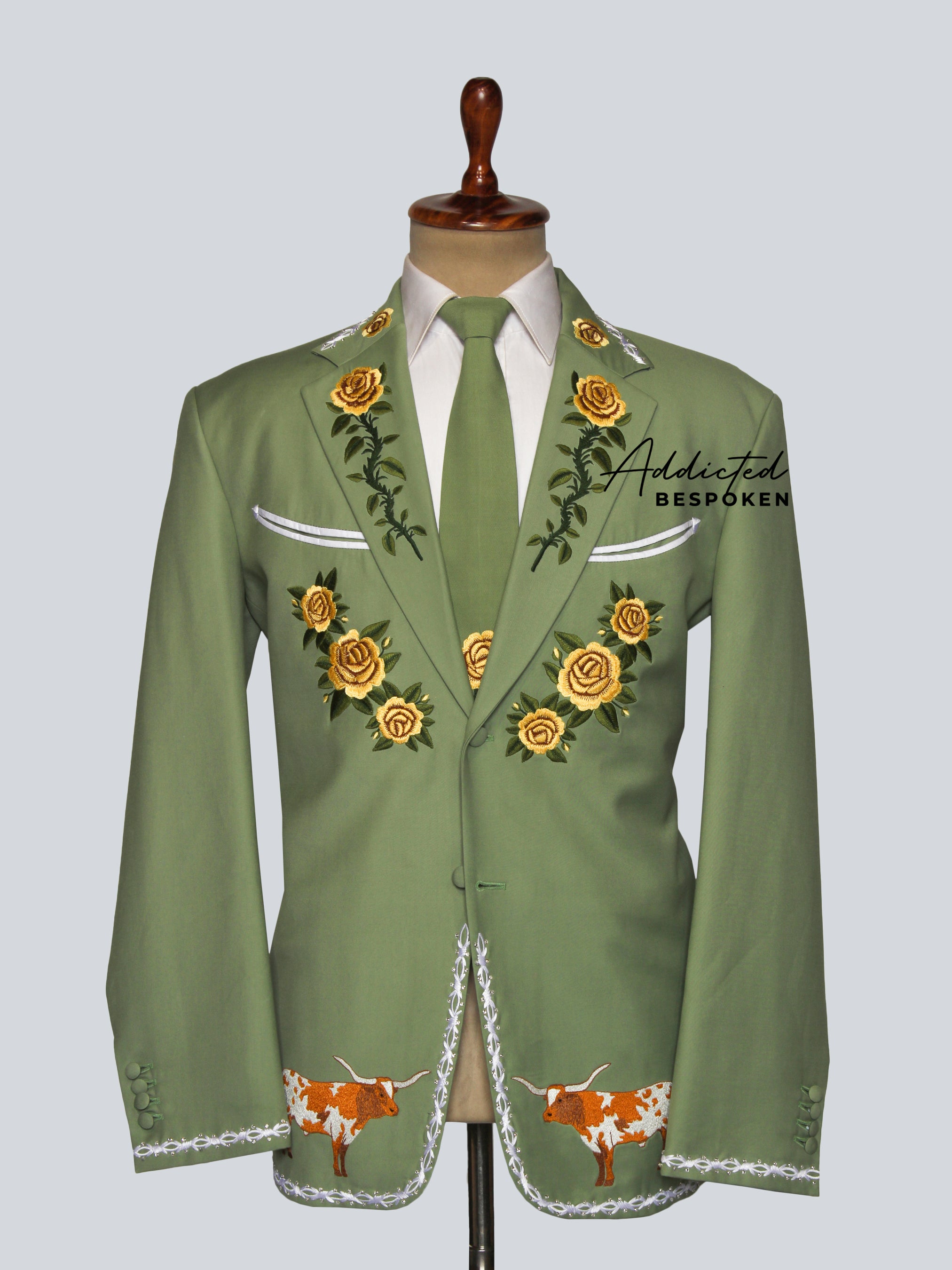 Green embroidered jacket on a mannequin with 'Addicted Bespoke' branding.