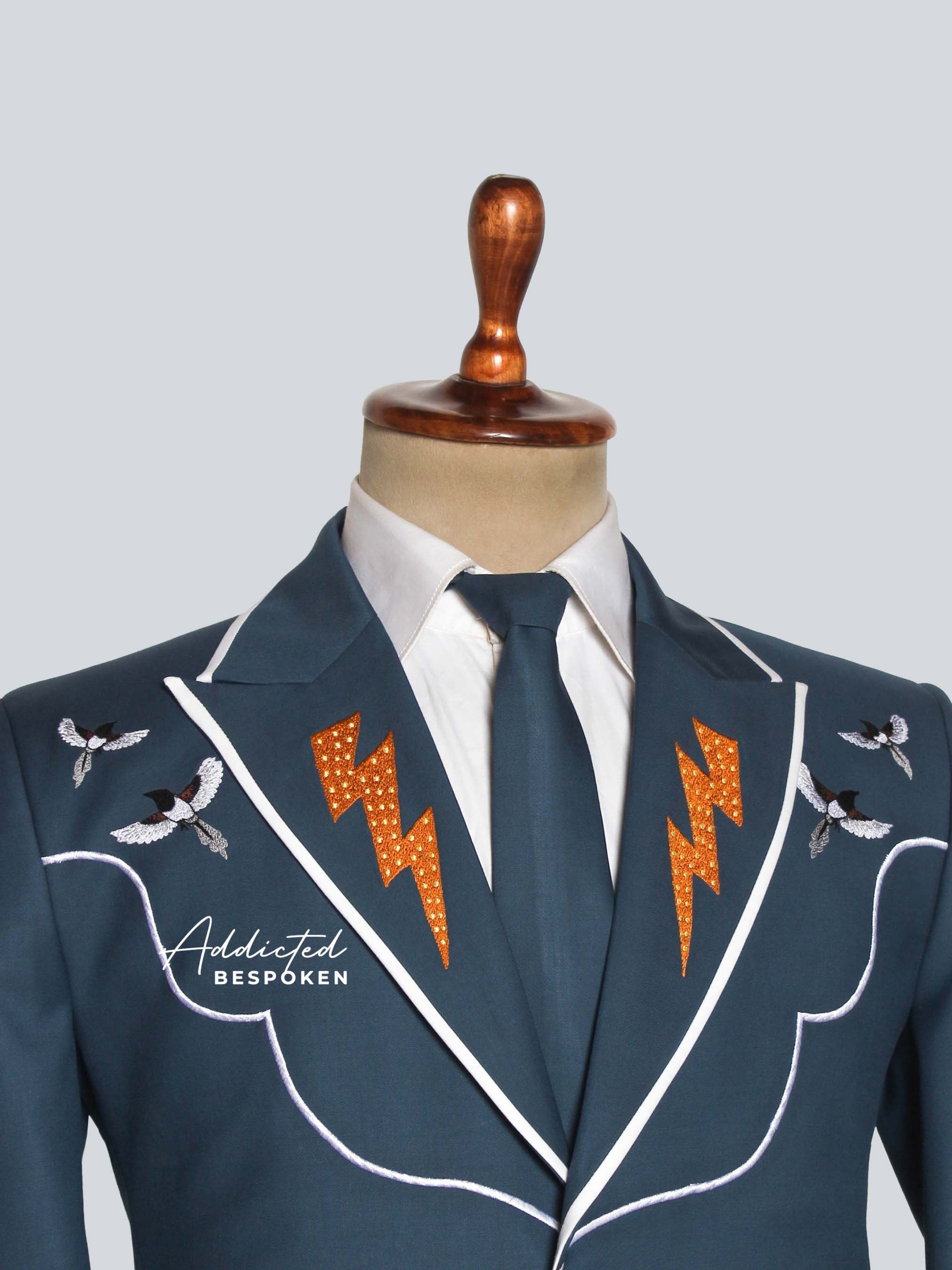 Blue blazer with lightning bolt designs on a mannequin against a light gray background