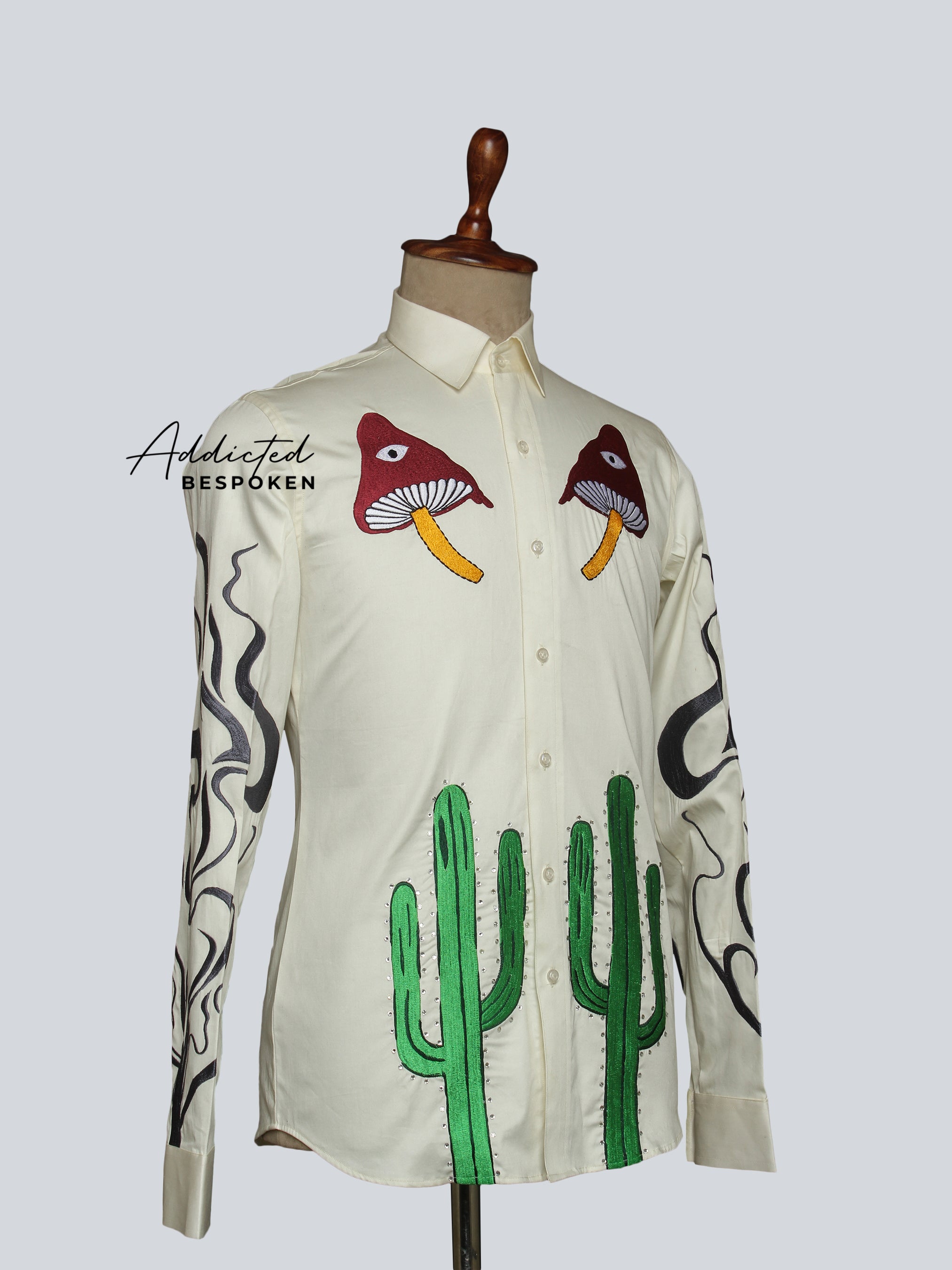 Angled front view of cream shirt with cactus embroidery and bird motifs โ Addicted Bespoken