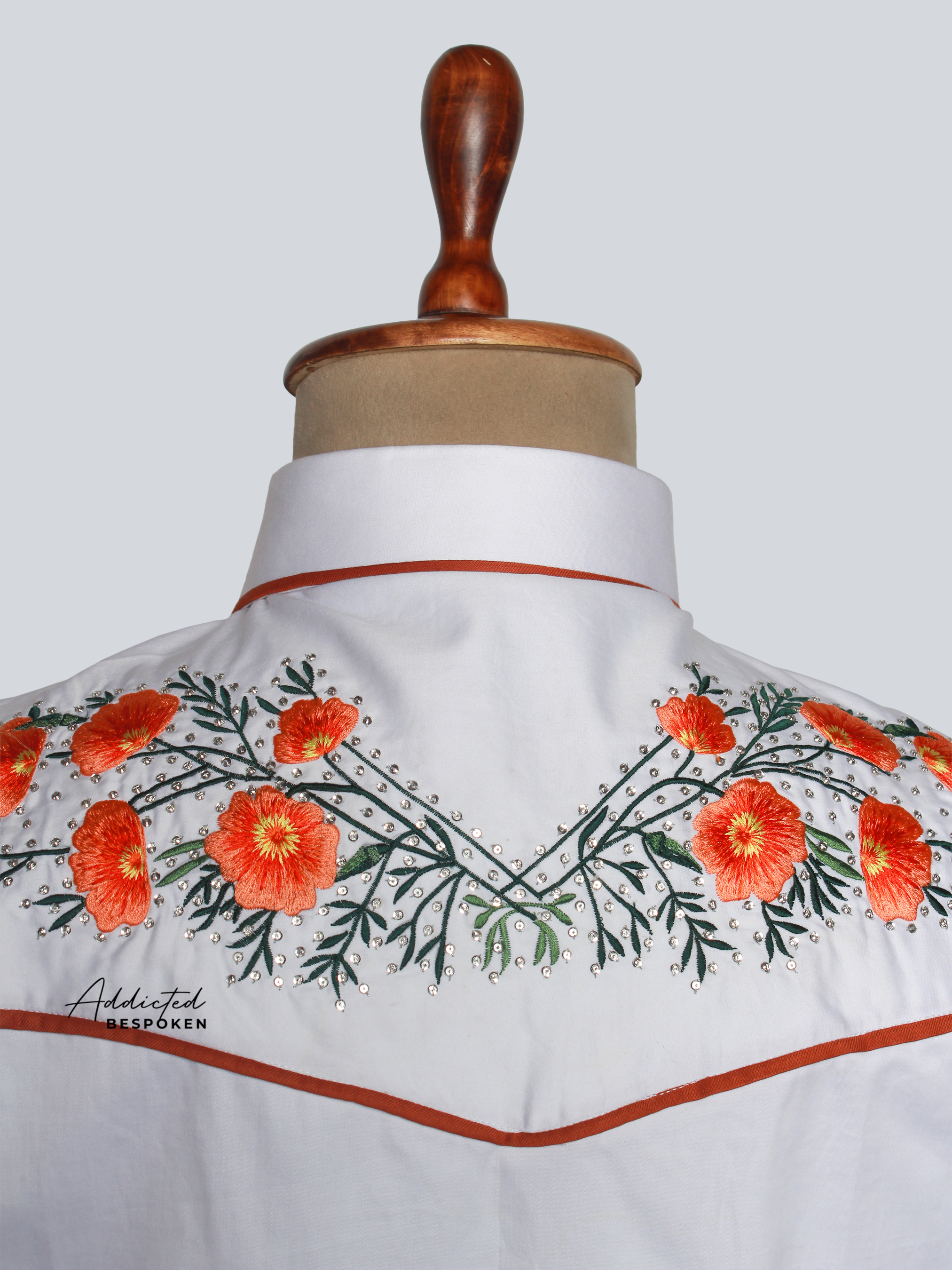 Close-up of floral embroidery detail on collar and shoulders of white western shirt – Addicted Bespoken