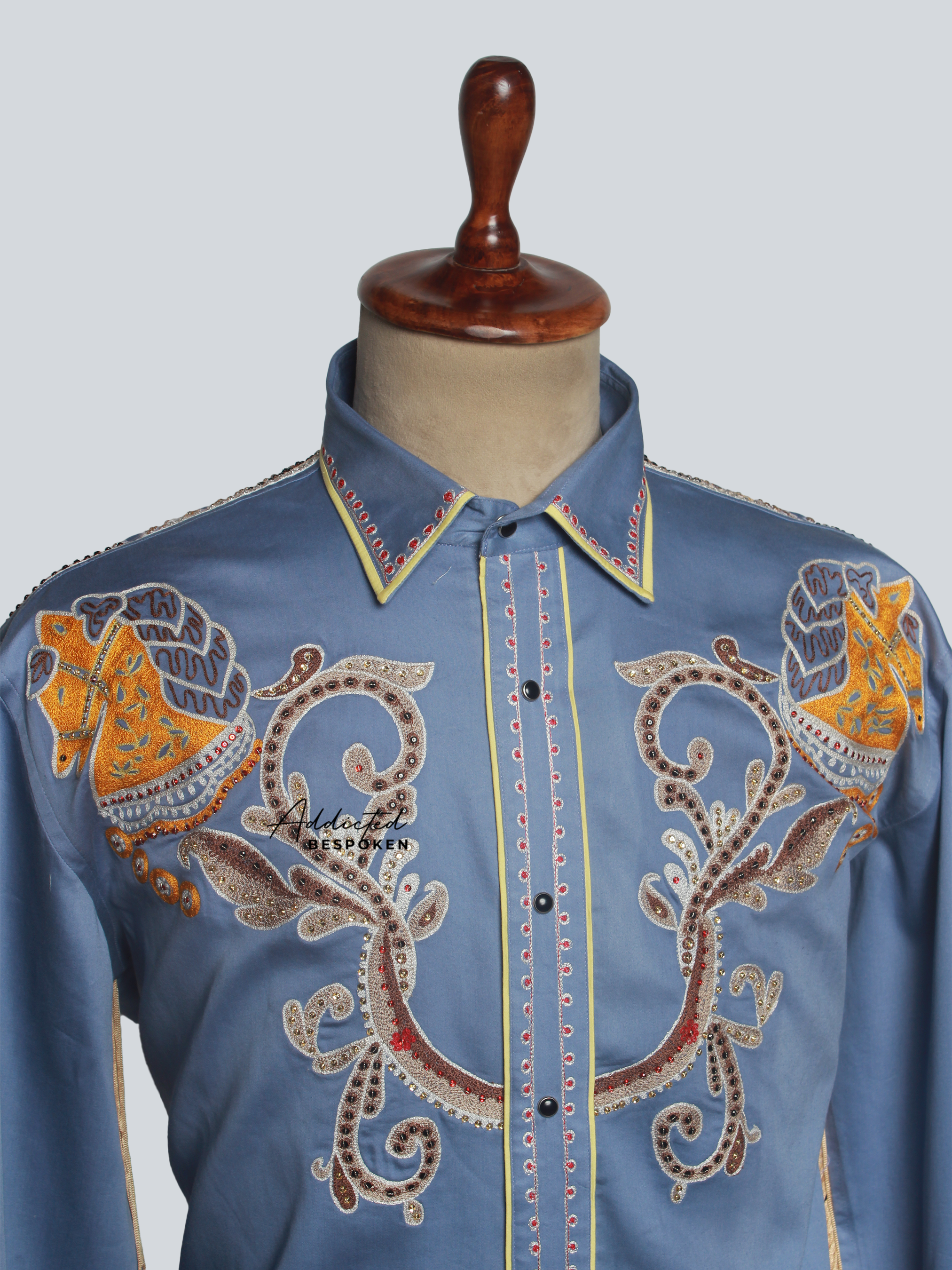 Close-up of golden embroidery on chest of light blue western shirt β Addicted Bespoken