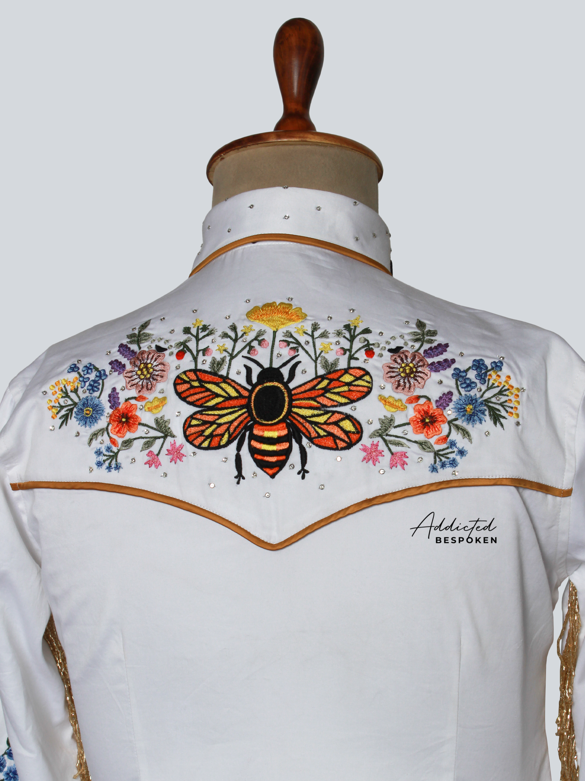 Rear angled view of white embroidered western shirt with colorful floral motif – Addicted Bespoken