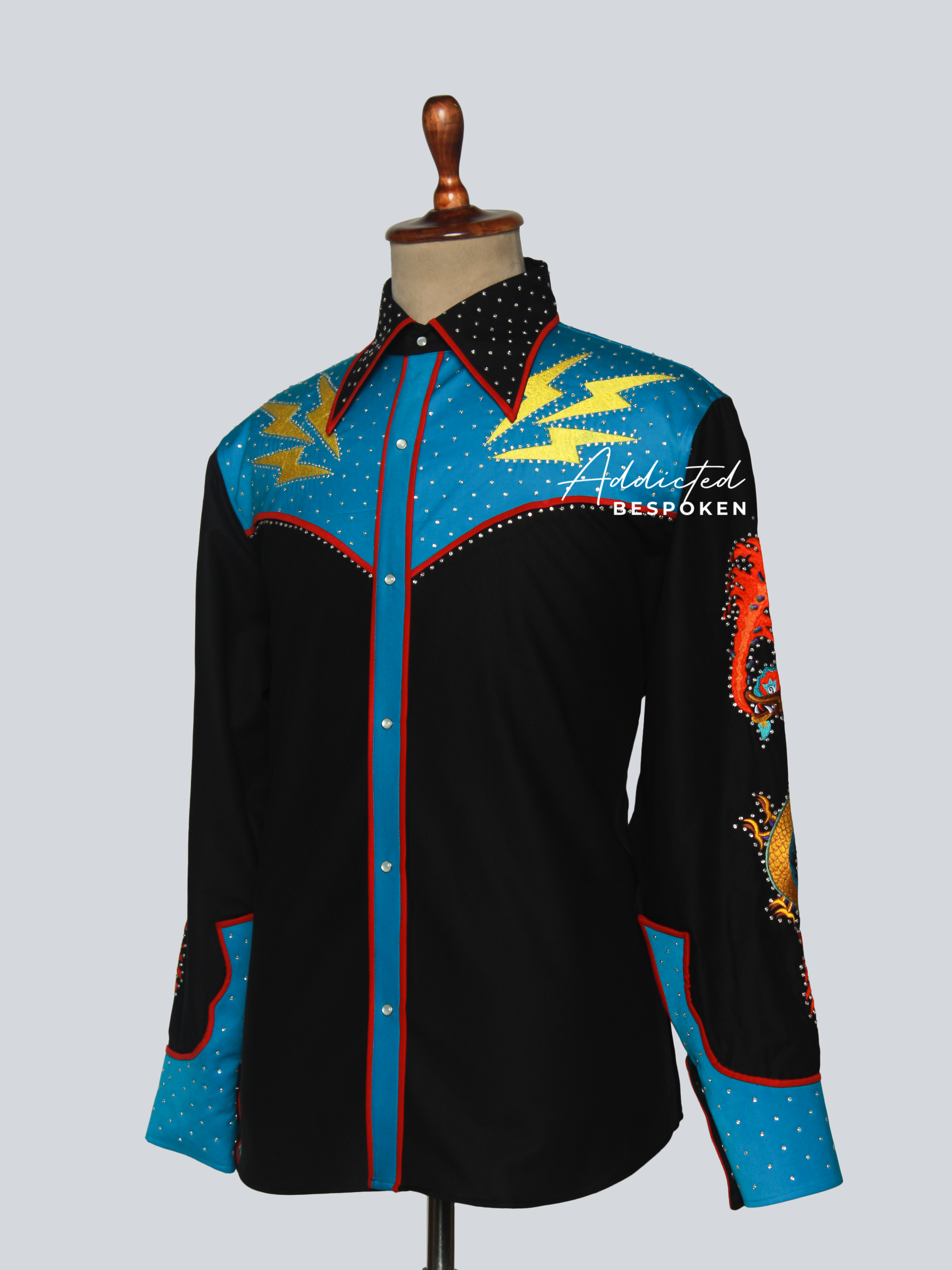 Side angled view of black western shirt with blue sleeves and yellow embroidery – Addicted Bespoken