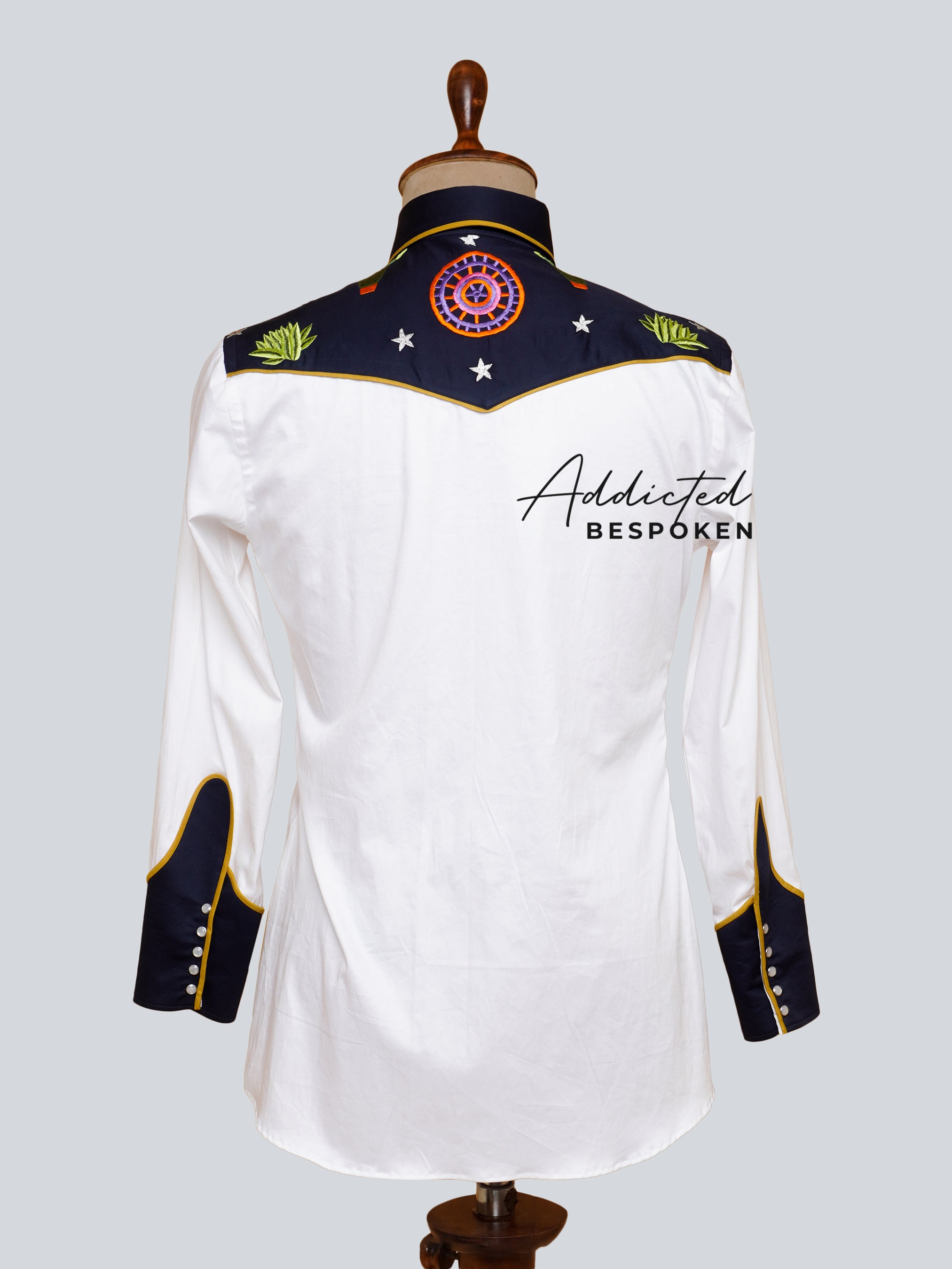 Back view of white embroidered western shirt with black yoke and floral motif – Addicted Bespoken