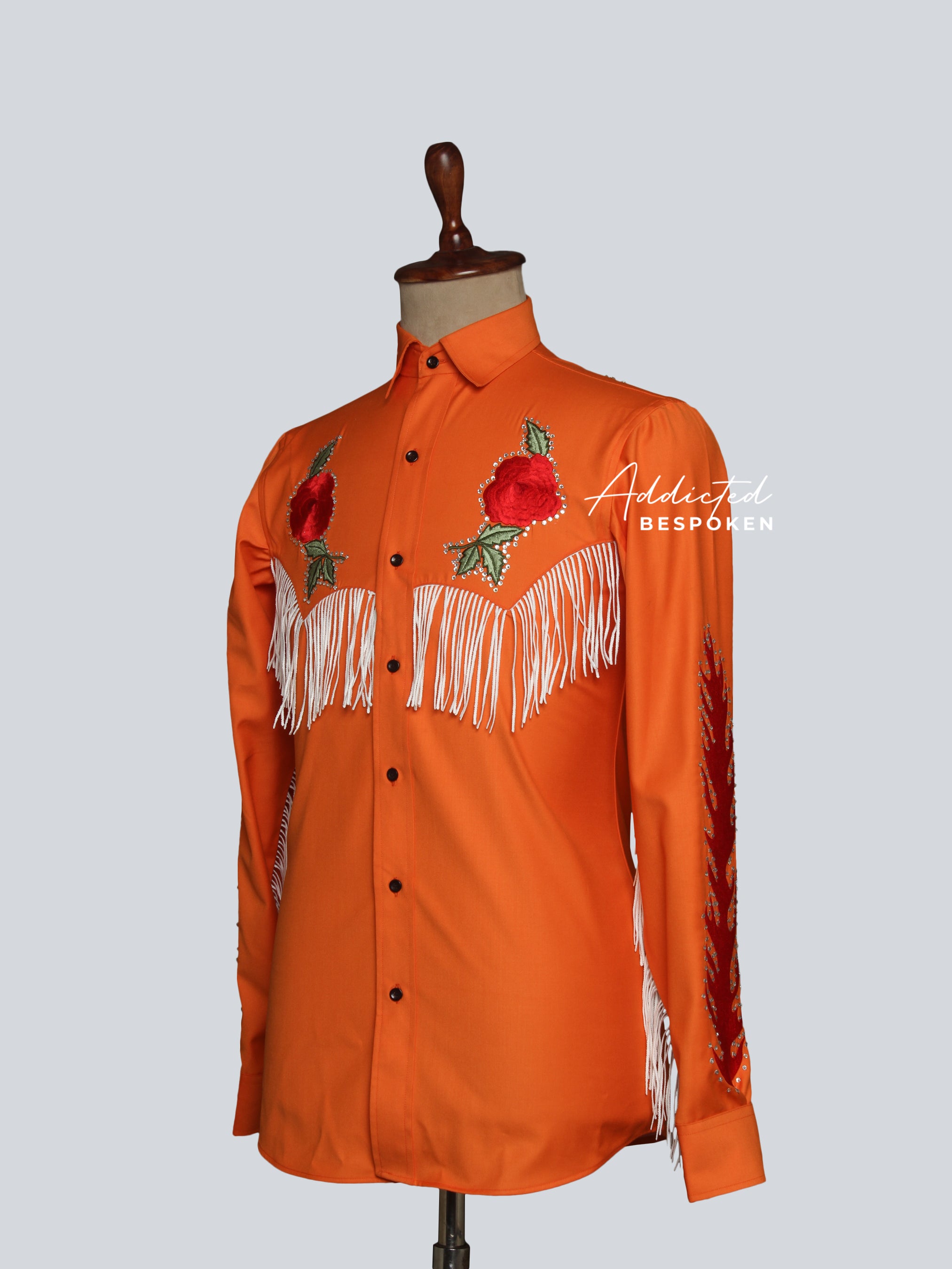 Mannequin view of orange western shirt with floral embroidery on chest and shoulders โ Addicted Bespoken