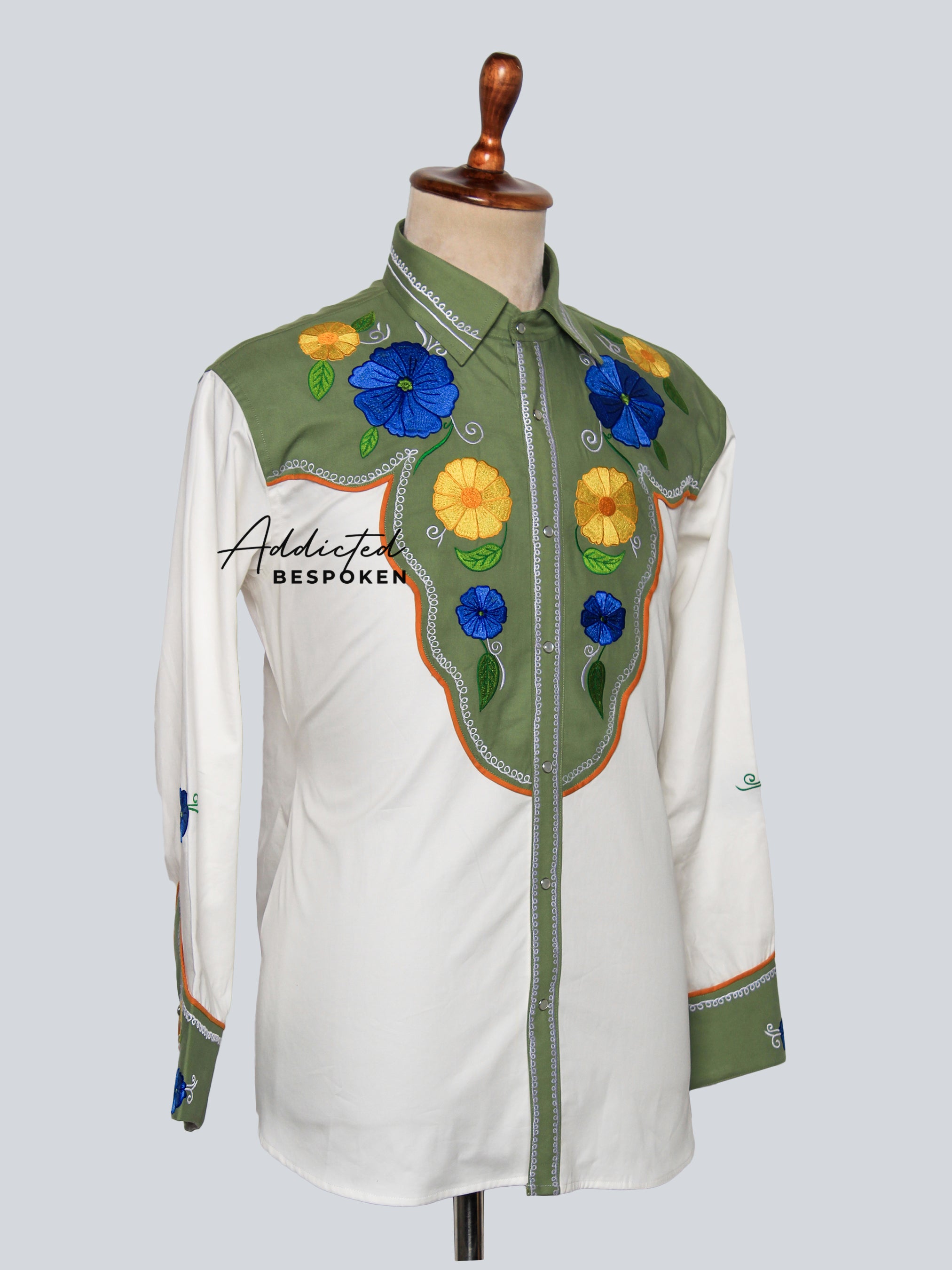 Angled side view of white shirt with green accents and embroidered floral motifs – Addicted Bespoken