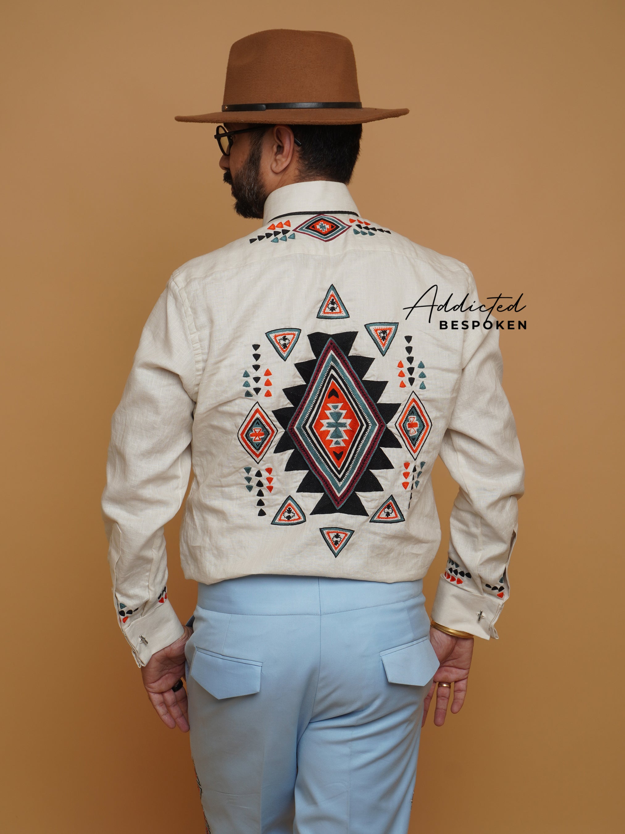 Back view of cream western shirt with large embroidered motif, worn by male model β Addicted Bespoken