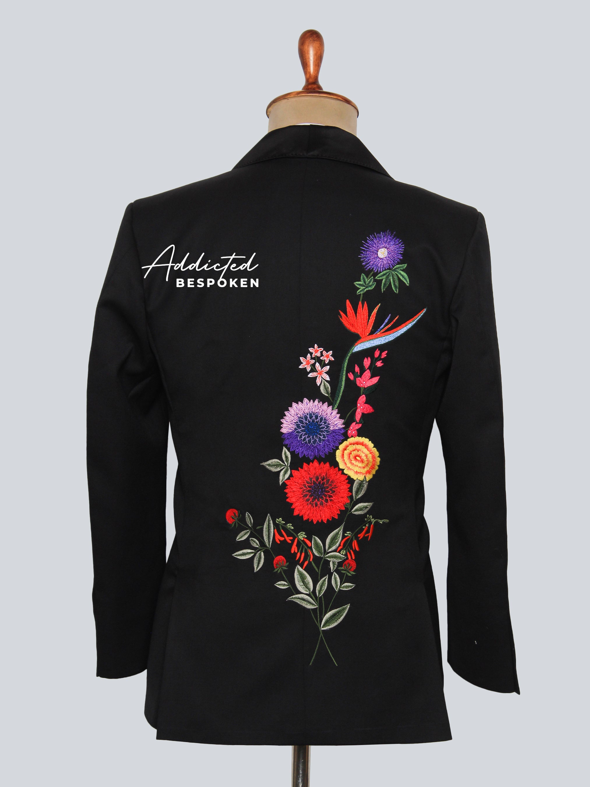 Back view of black embroidered blazer with vibrant floral detailing