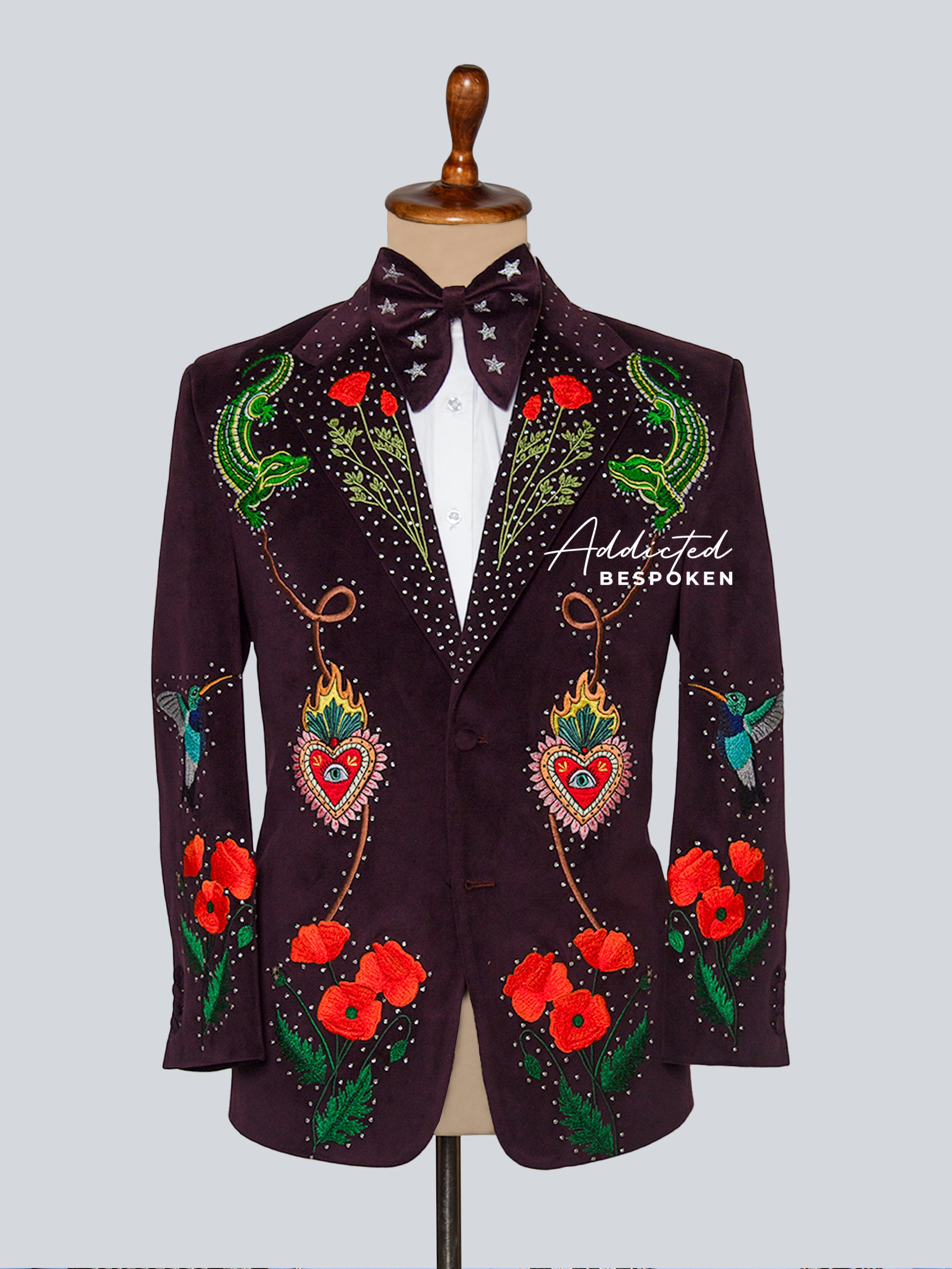 Decorative jacket with floral and heart designs on a mannequin against a light gray background.