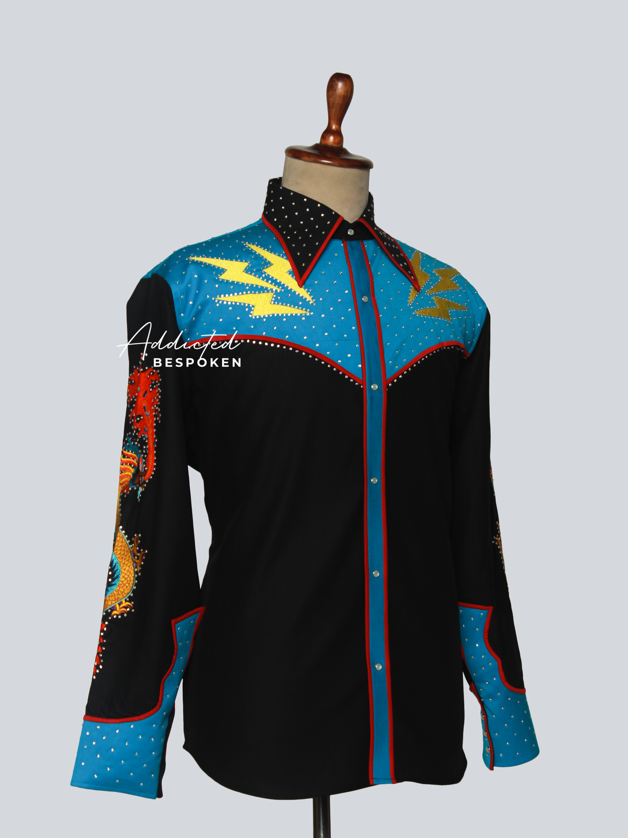 Angled front view of black shirt with blue yoke and embroidered starburst motifs – Addicted Bespoken