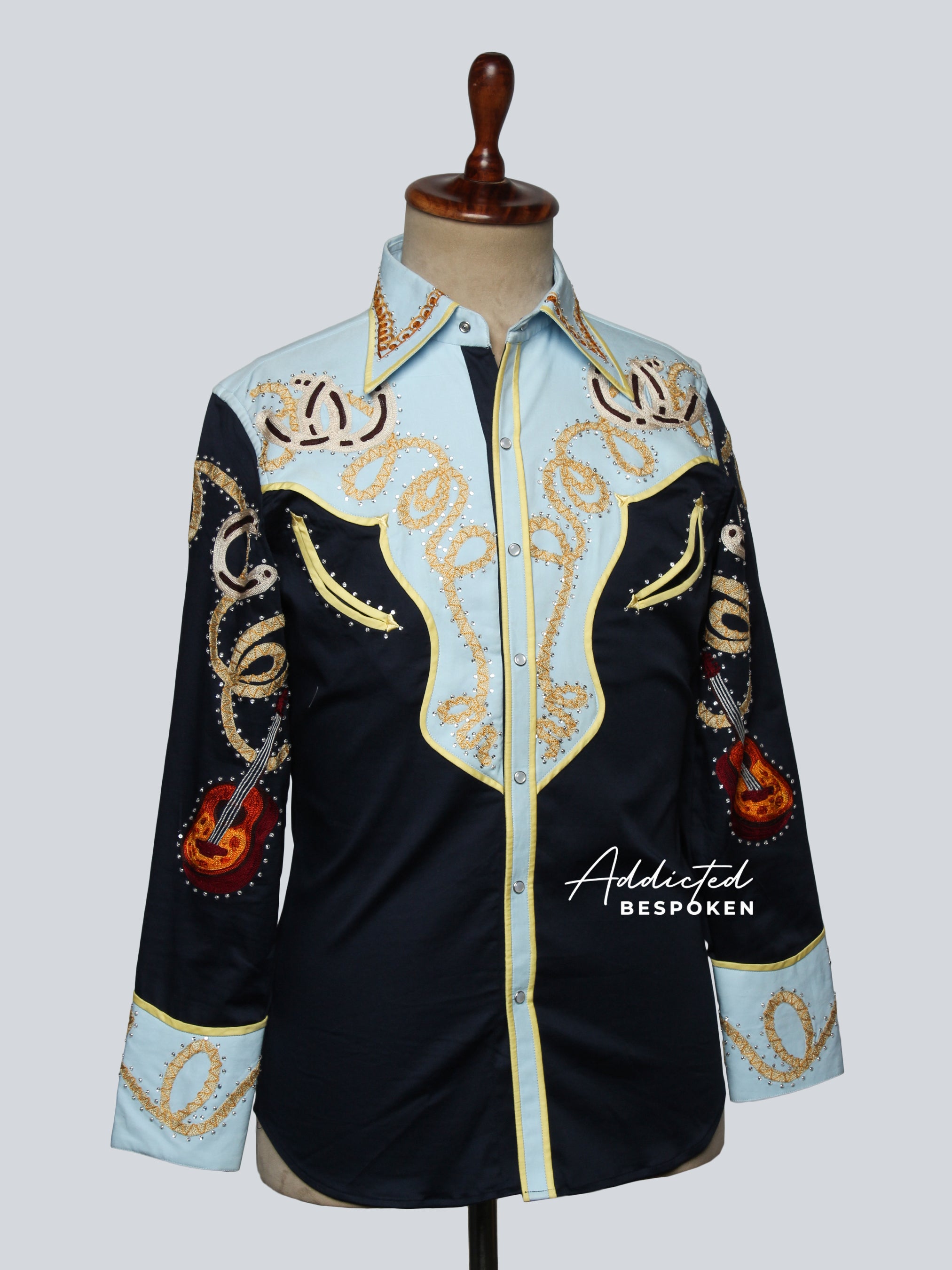 Side angled view of embroidered western shirt with golden motifs on mannequin – Addicted Bespoken