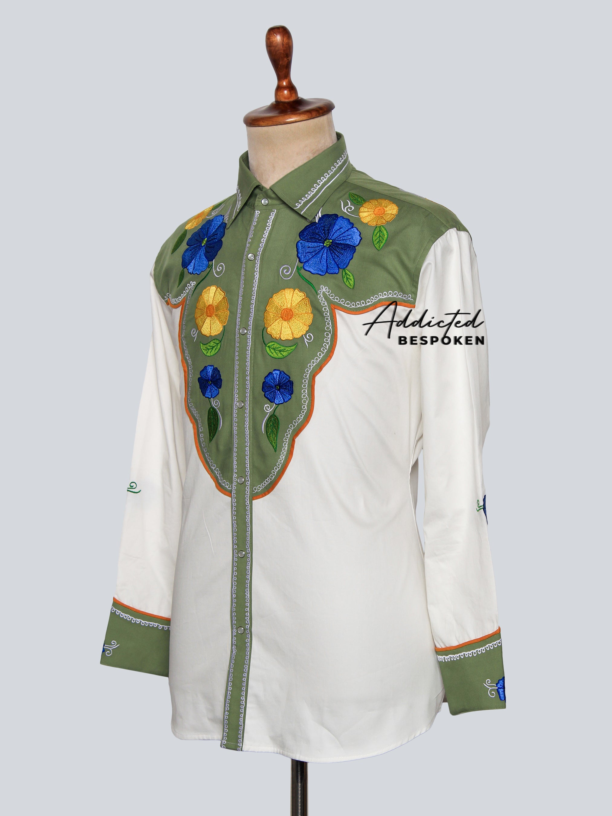 Front angled view of white embroidered western shirt with green cuffs and piping – Addicted Bespoken