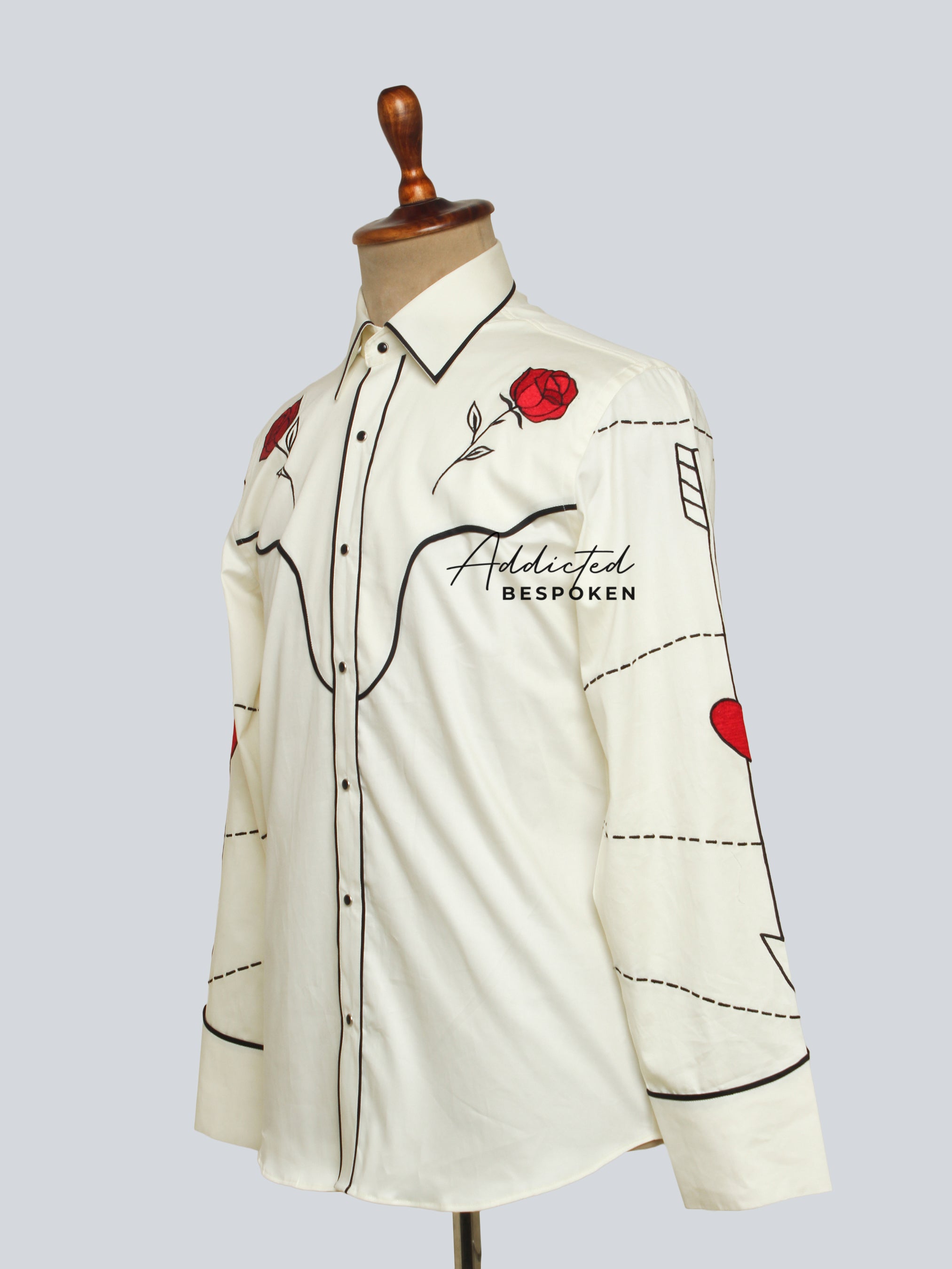 Rear angled mannequin view of cream embroidered western shirt with black piping โ Addicted Bespoken