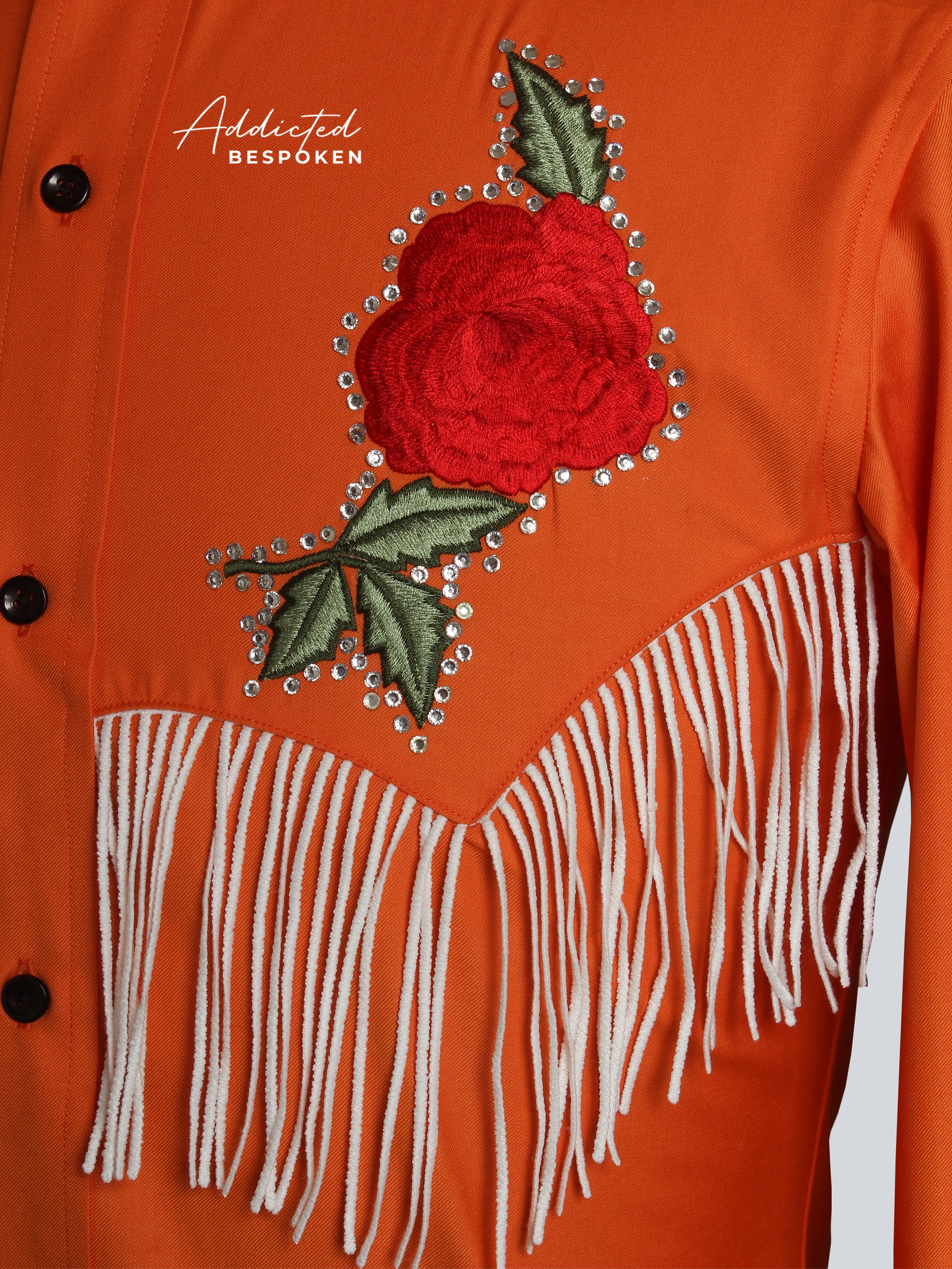 Close-up of embroidered red rose on orange western shirt โ Addicted Bespoken