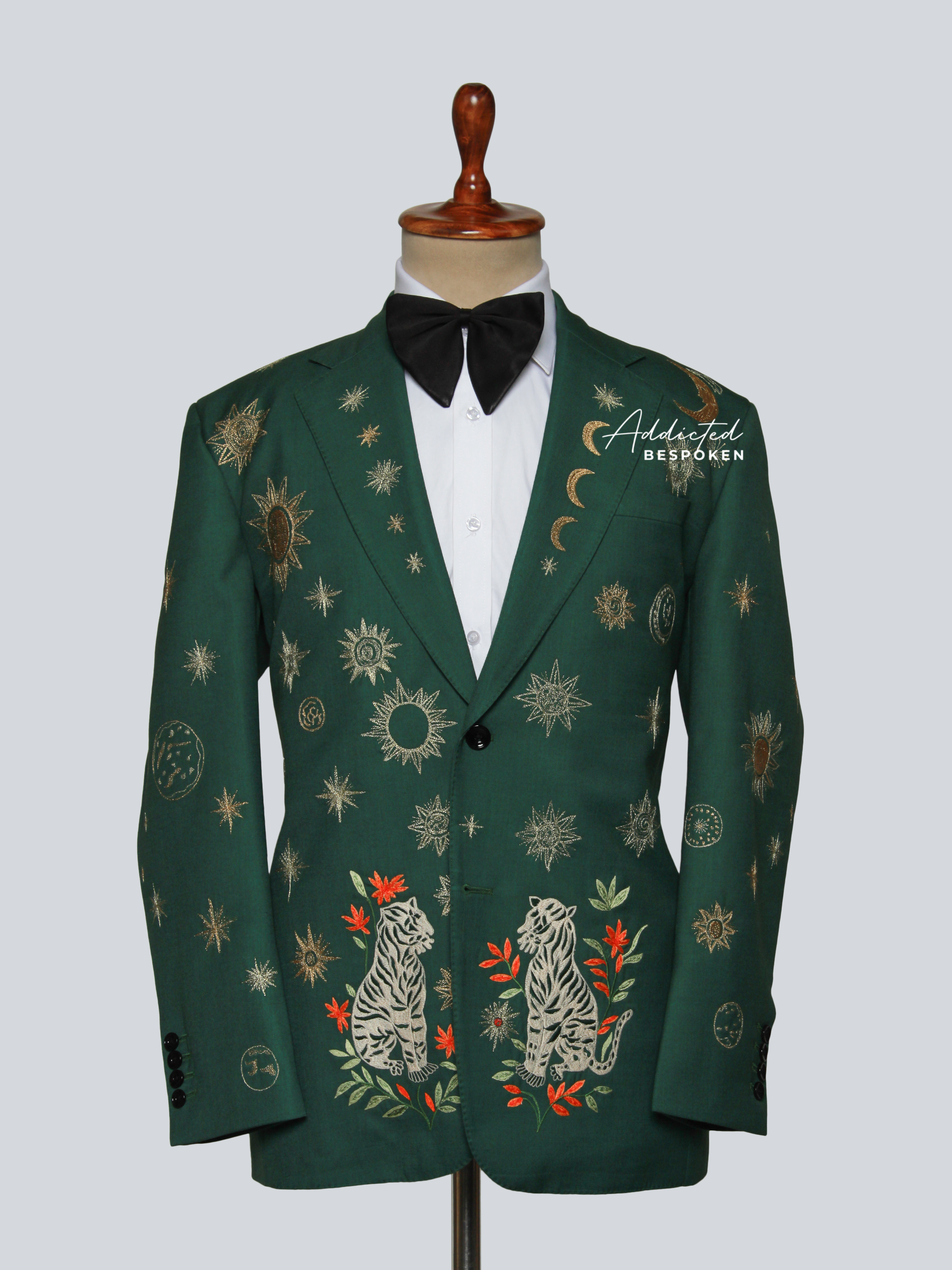 Green embroidered blazer on a mannequin with a white background
