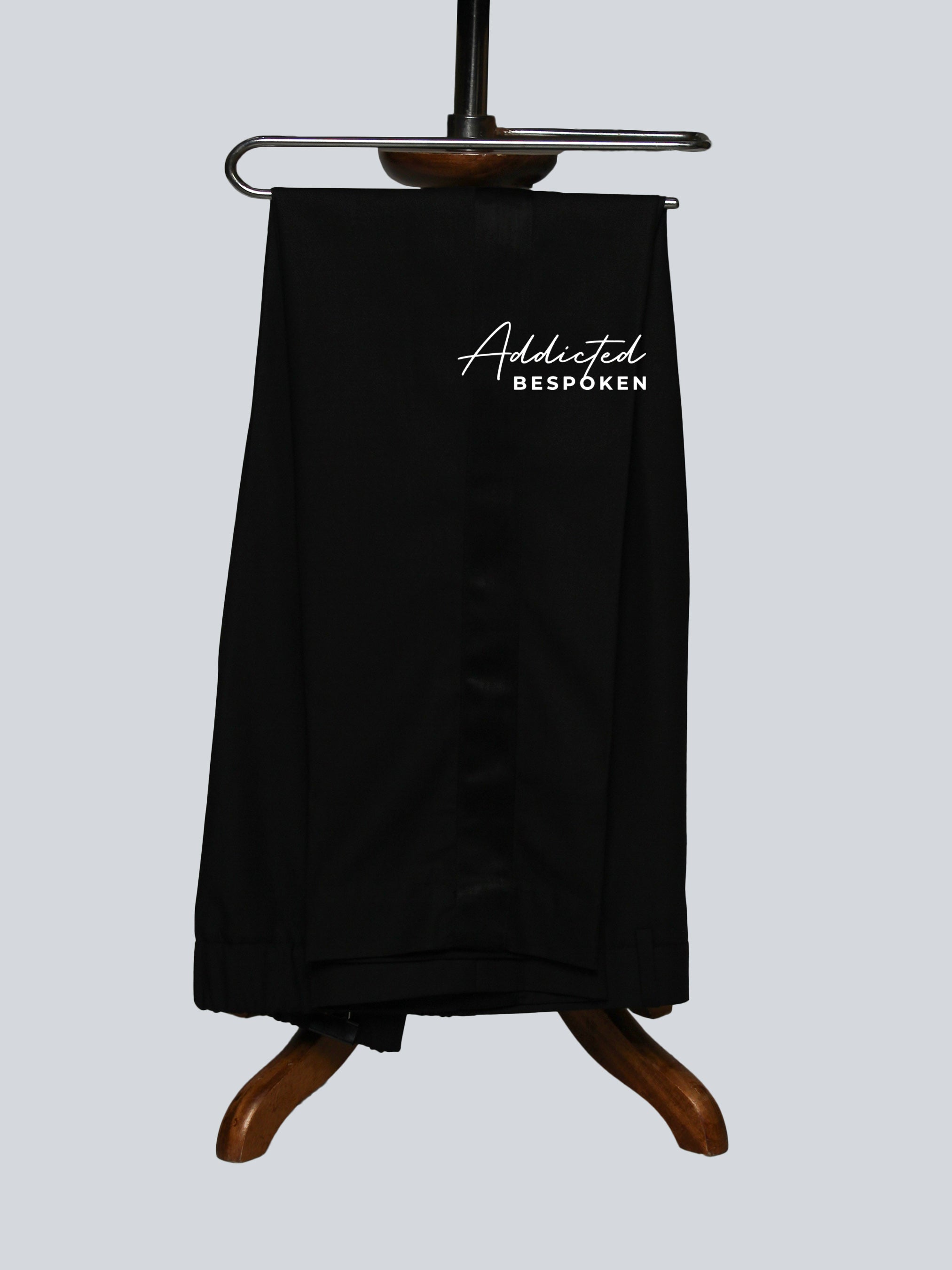 Black Pant on a wooden hanger with 'Addicted Bespoken' branding on a light gray background