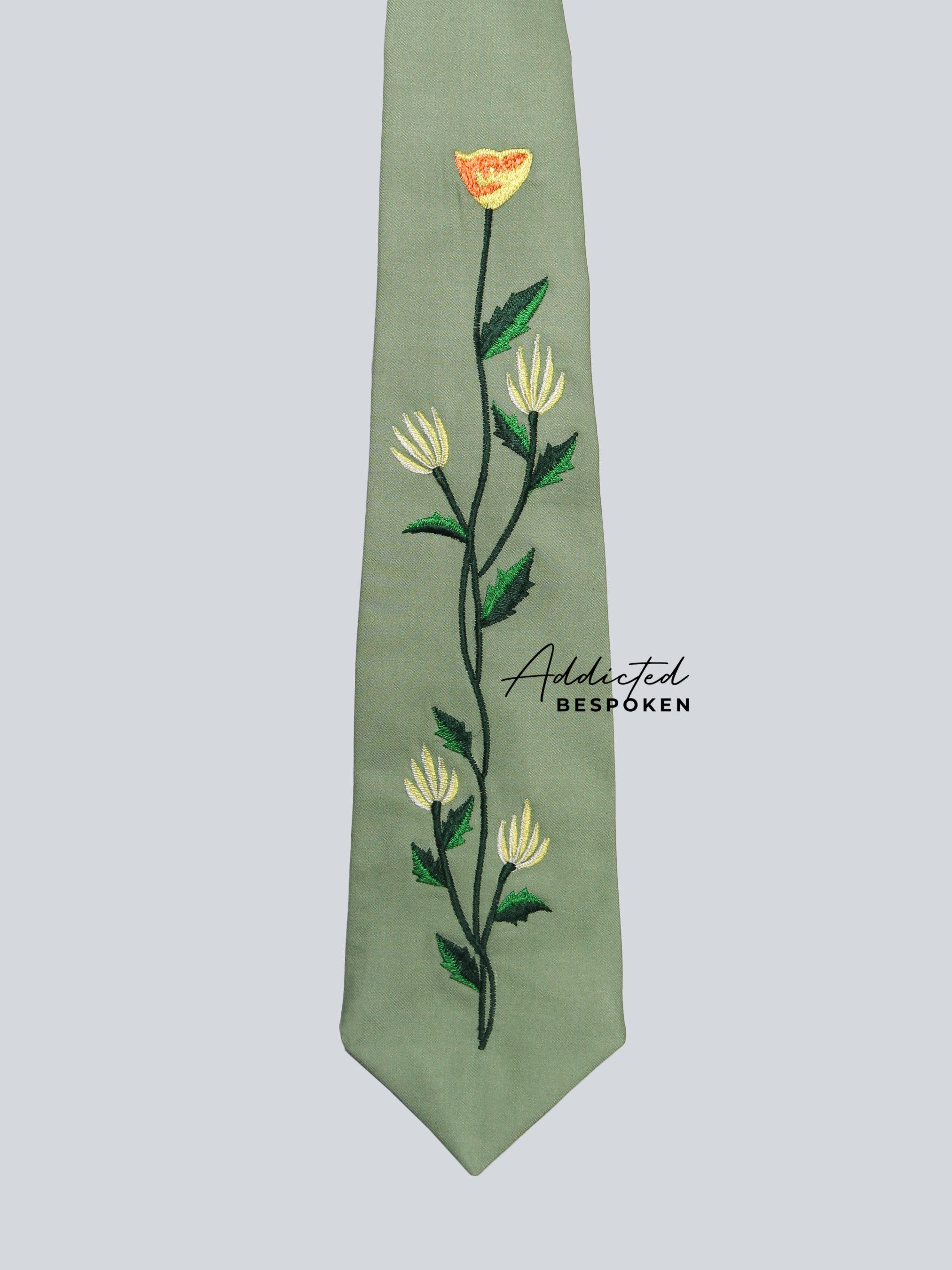 Sun Bloom Western Suit tie close-up – green necktie with floral embroidery detail matching the suit