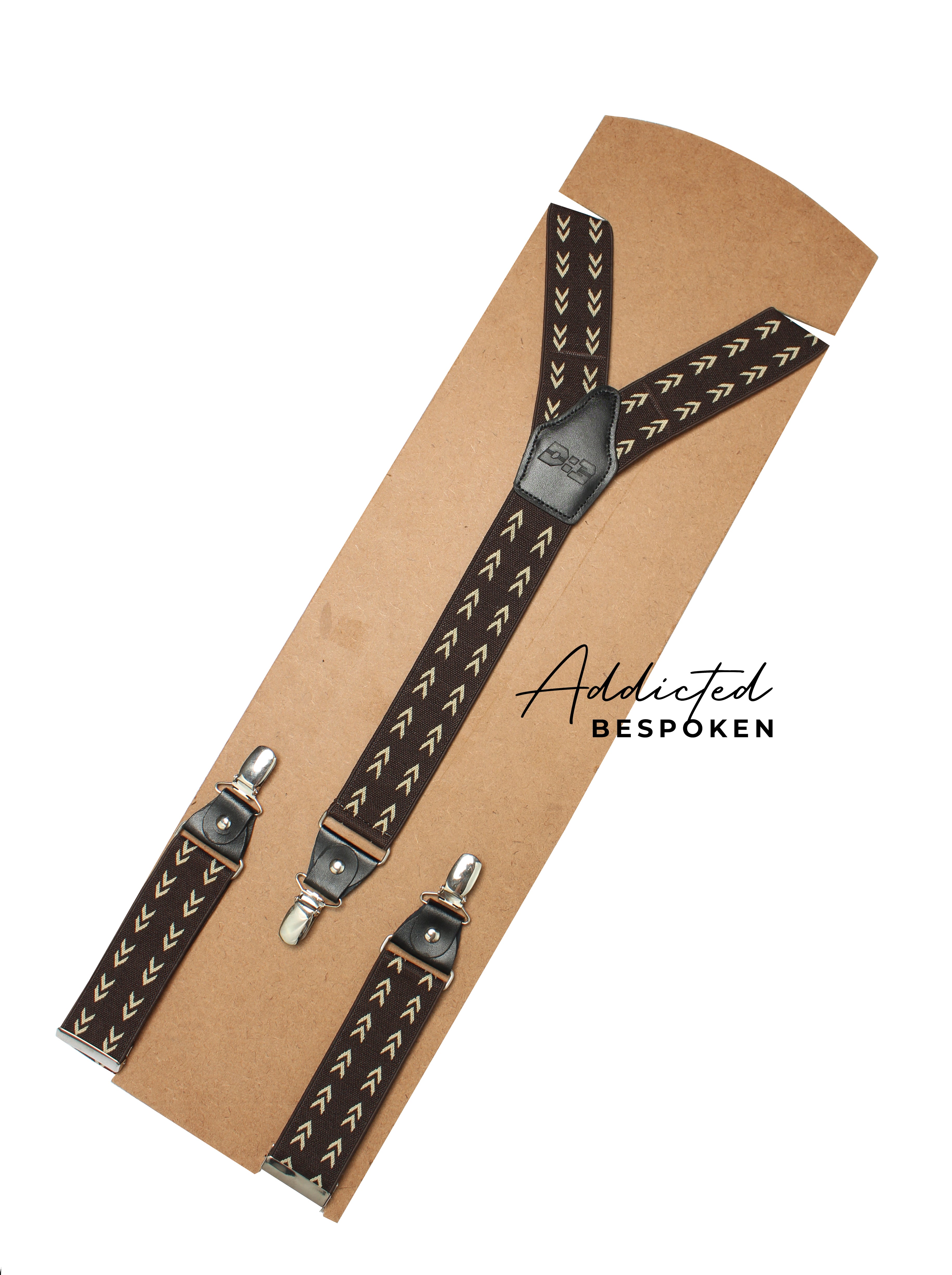 Brown patterned suspenders with metal clips from Addicted Bespoken displayed on a craft backing card