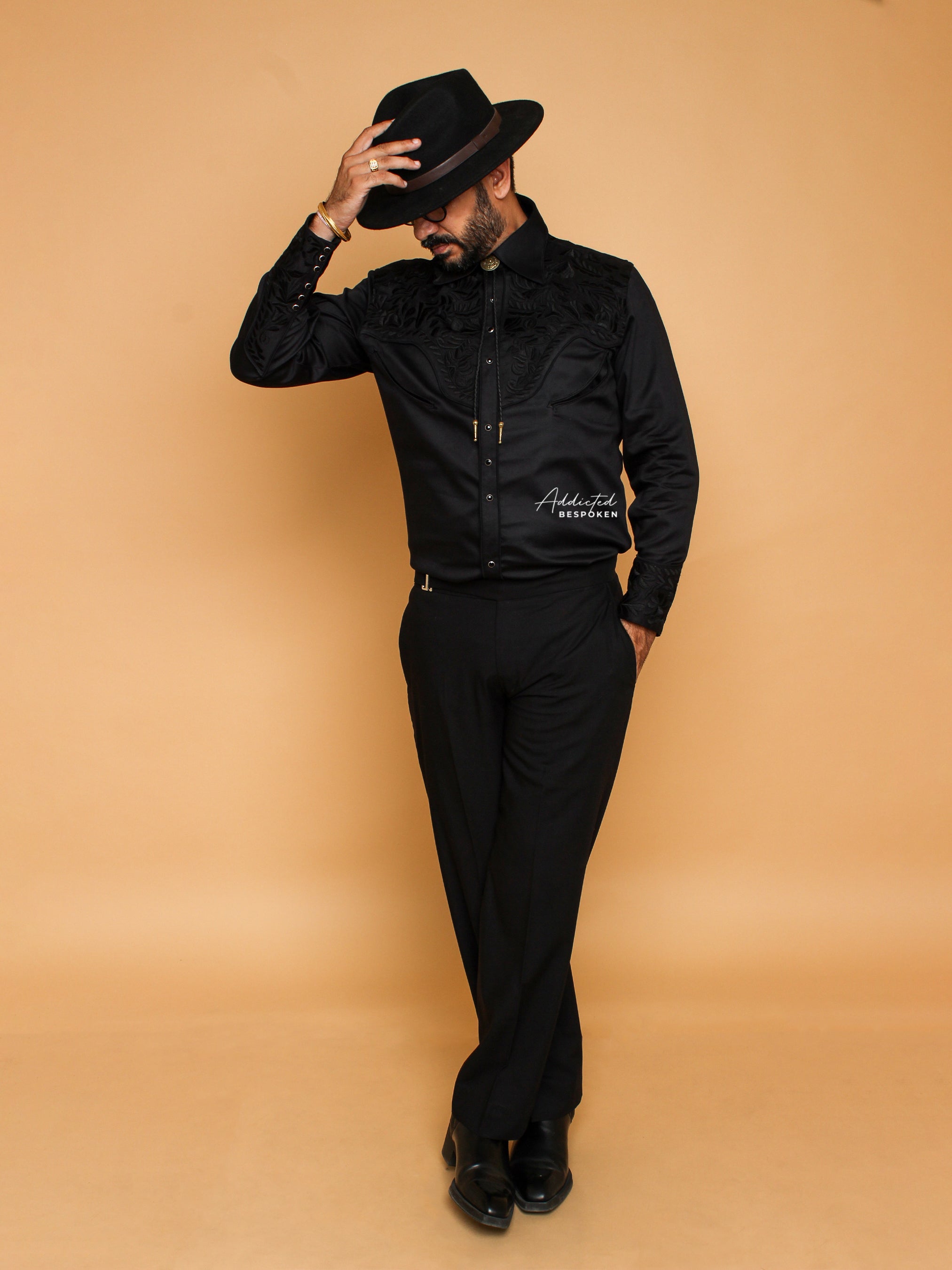 Full body view of male model wearing all-black embroidered western shirt with hat – Addicted Bespoken