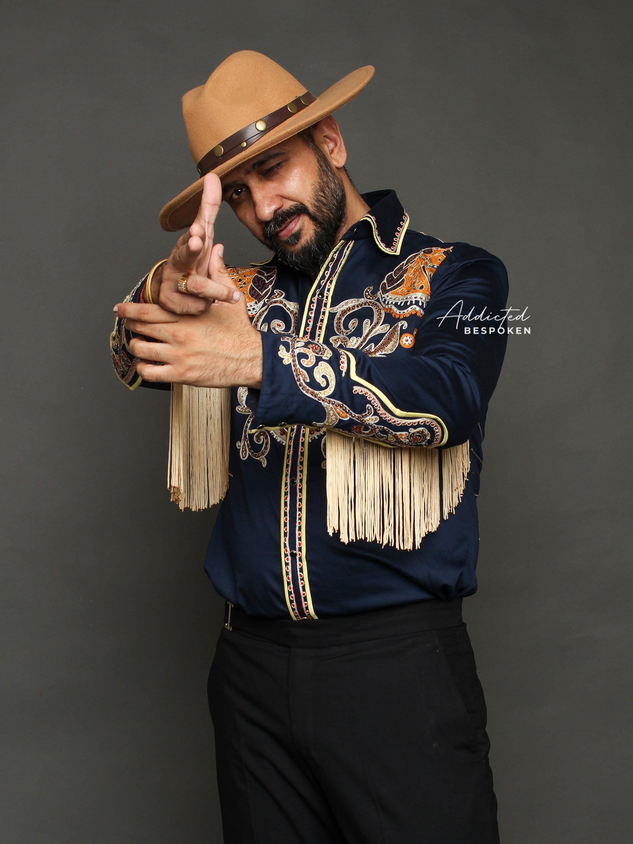 Pointing pose of male model wearing navy blue embroidered western shirt β Addicted Bespoken