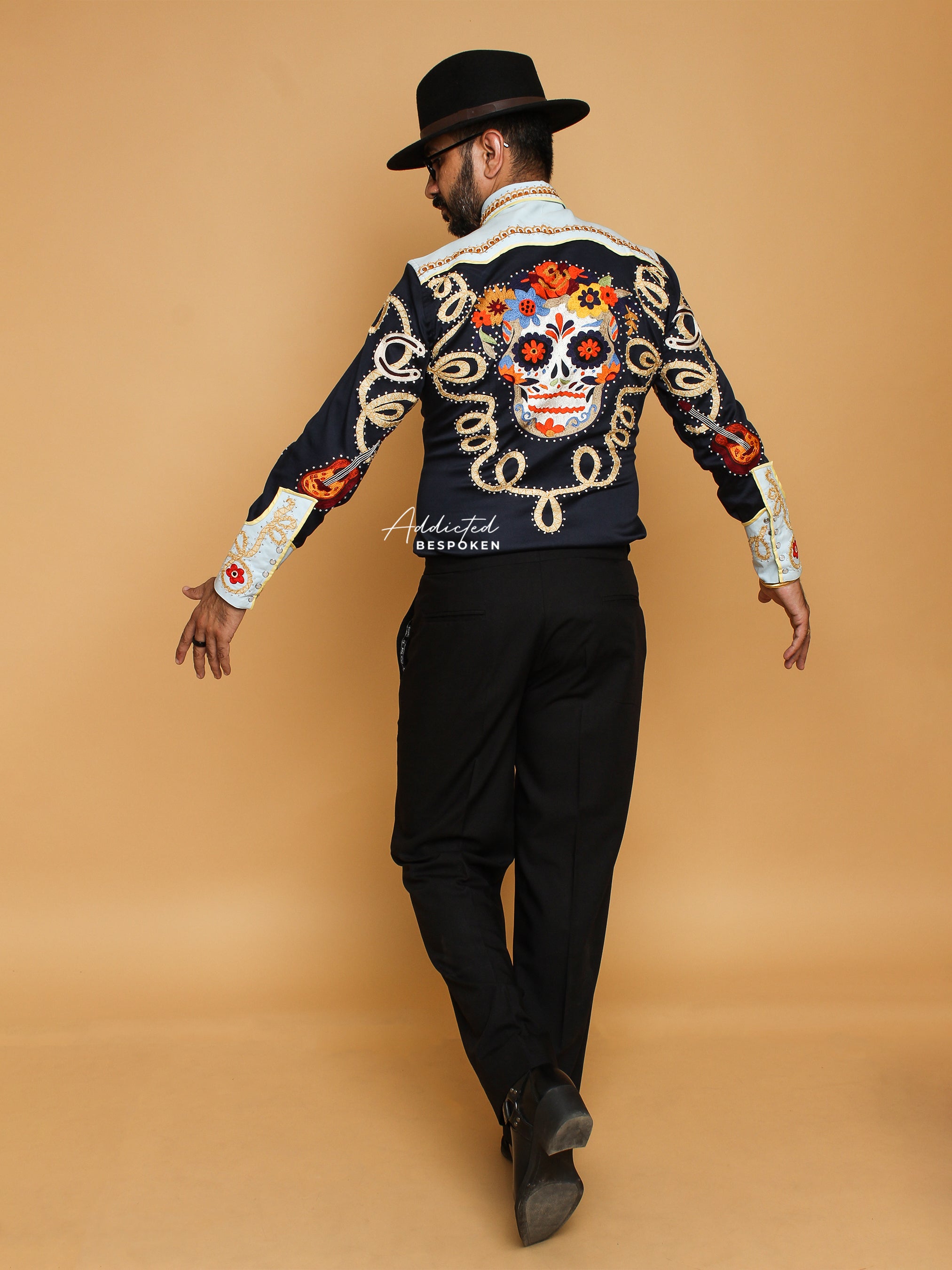 Back view of male model in black and cream embroidered western shirt with golden details – Addicted Bespoken