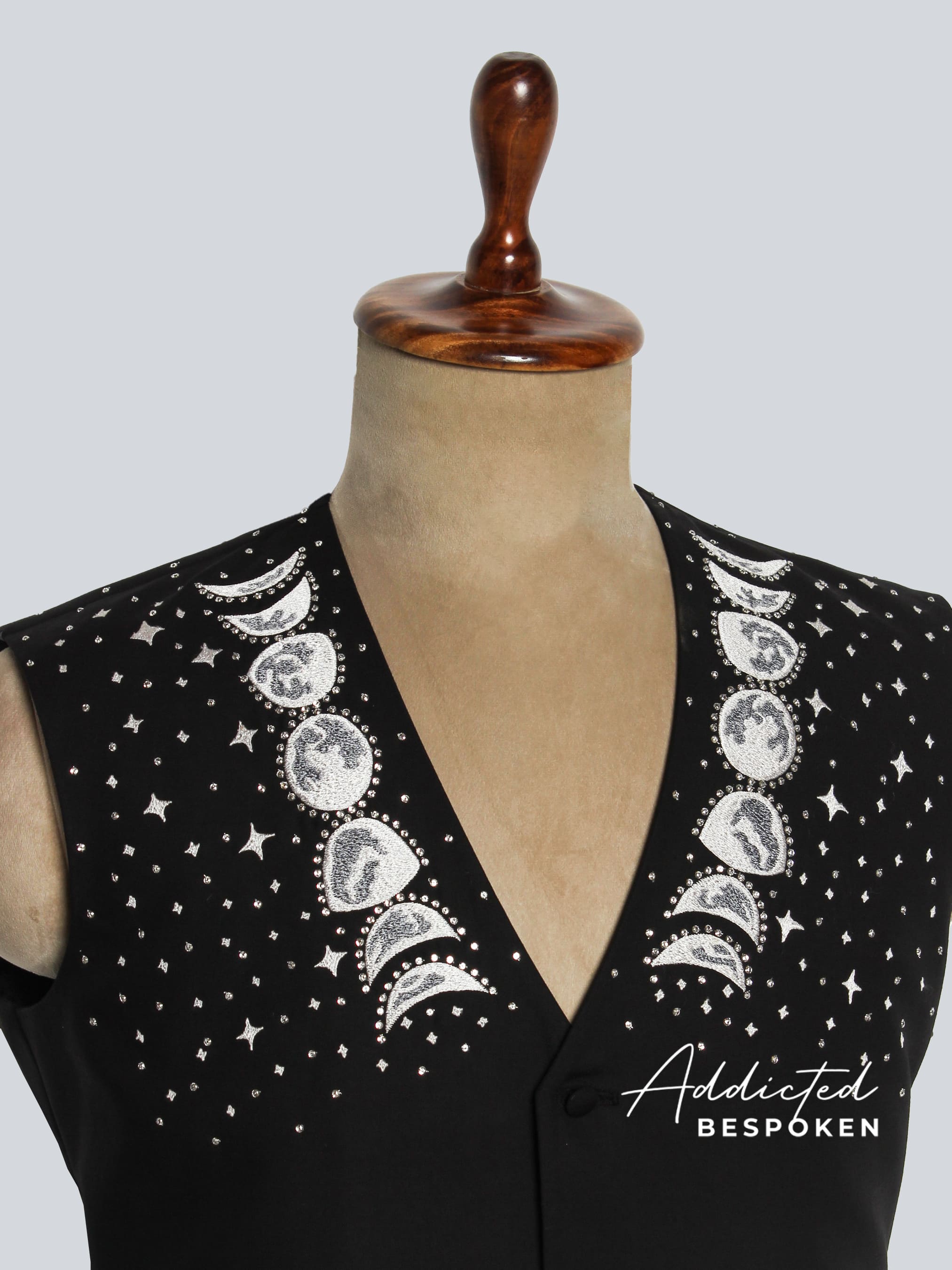 Black vest with celestial pattern on a mannequin, featuring the brand 'Addicted Bespoken'.