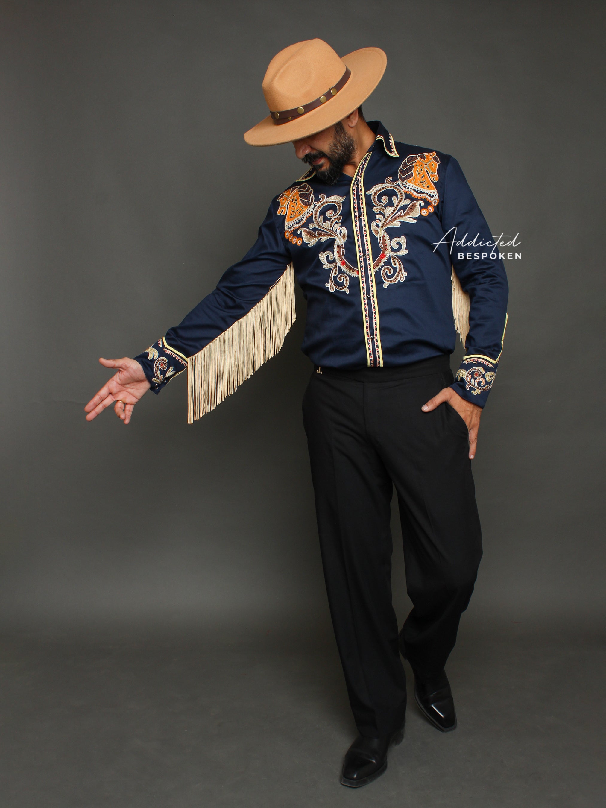 Action pose of male model in navy embroidered western shirt with fringe β Addicted Bespoken