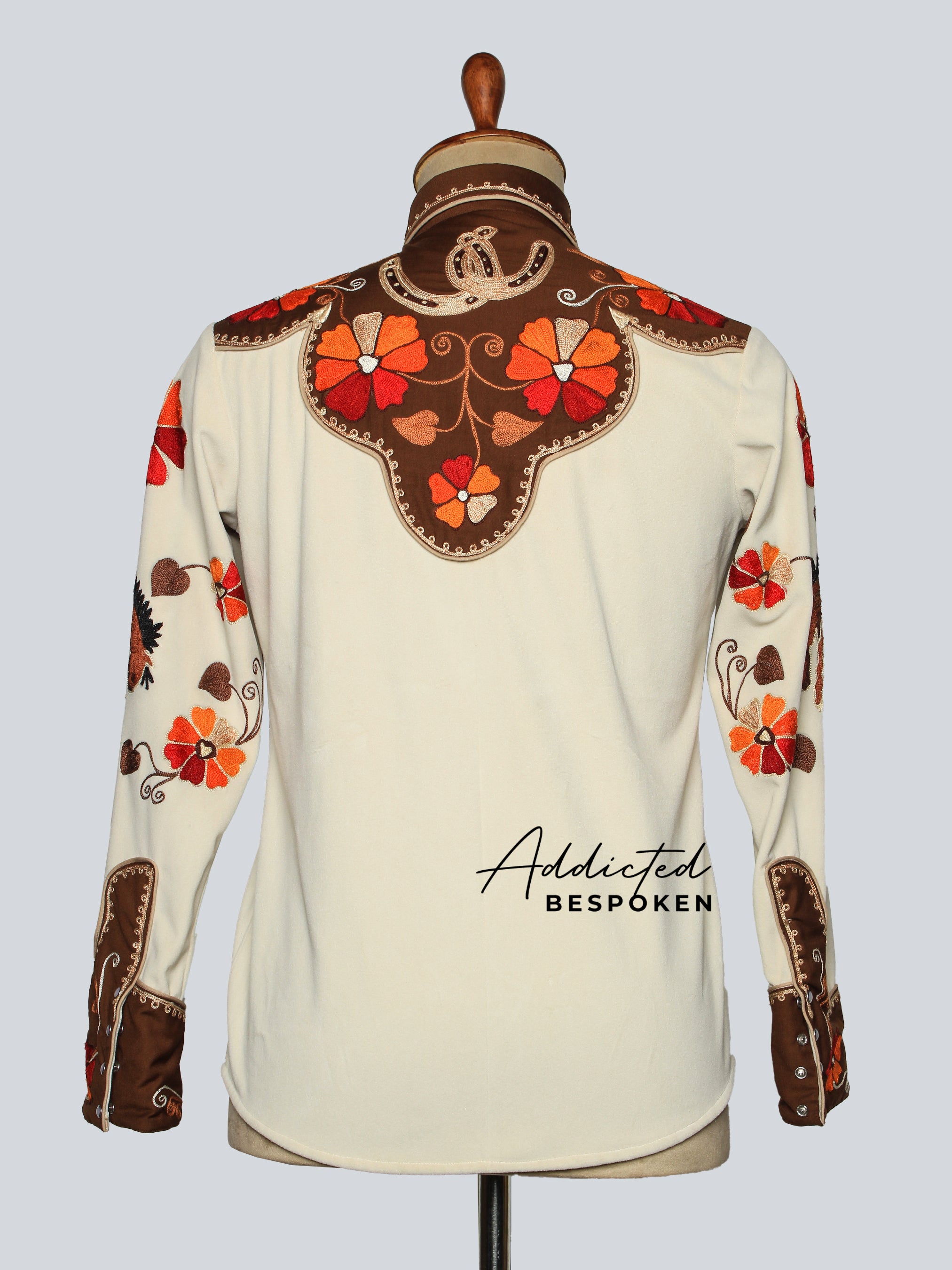 Back view of cream western shirt with red floral embroidery displayed on mannequin โ Addicted Bespoken