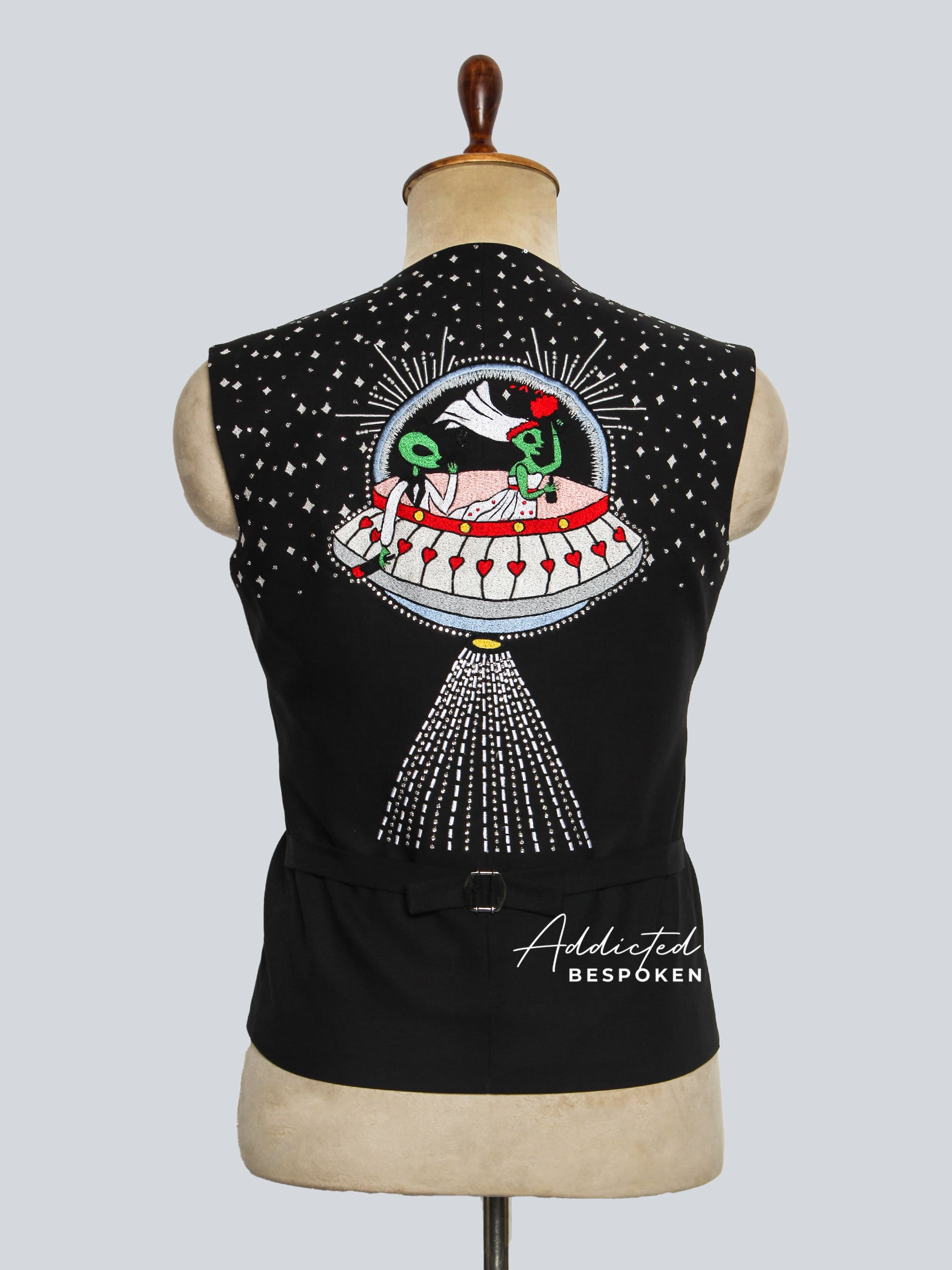 Black sleeveless vest with a colorful design on a mannequin against a gray background