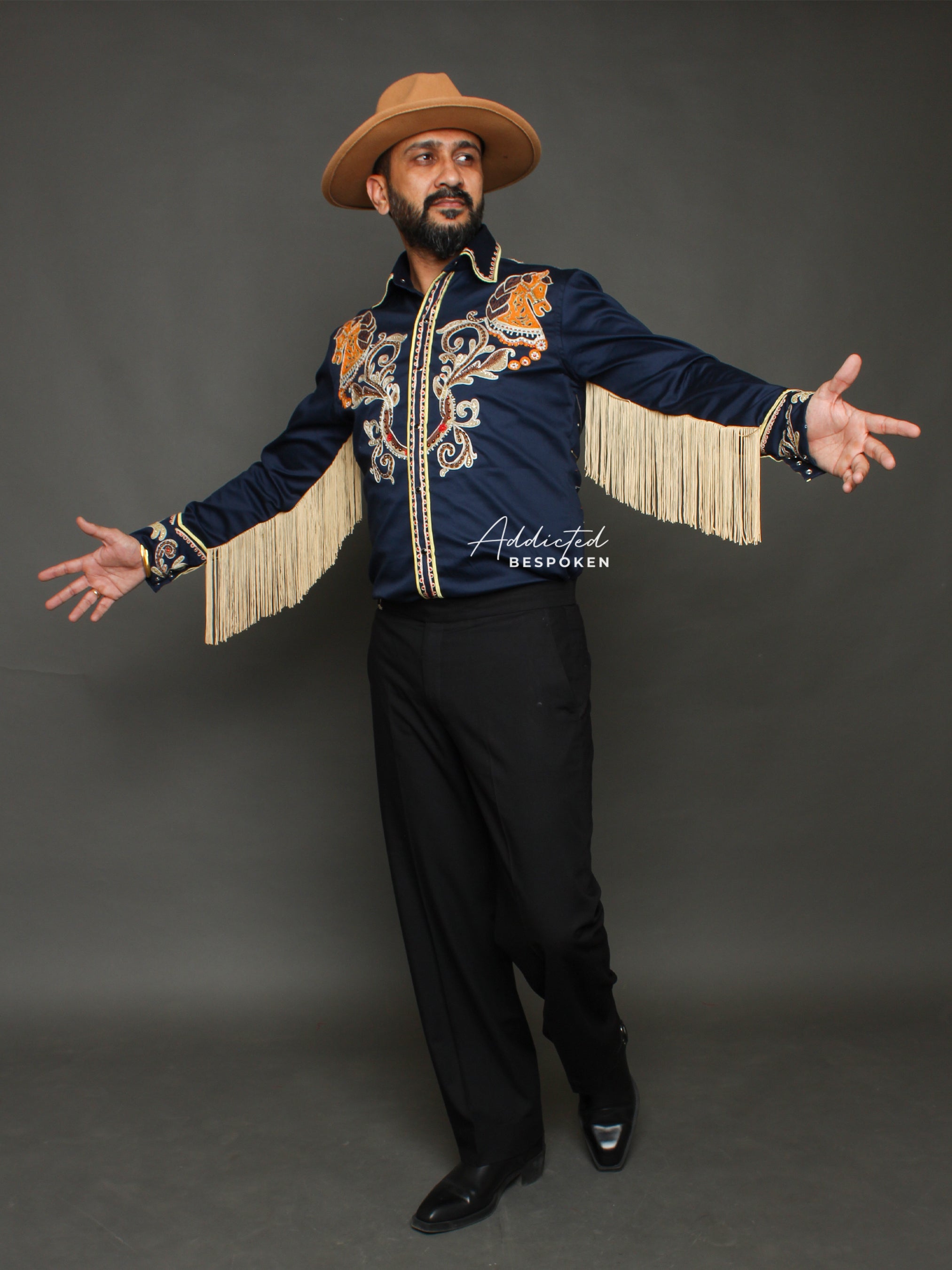 Full body view of male model wearing navy blue embroidered western shirt with golden fringe and black trousers – Addicted Bespoken