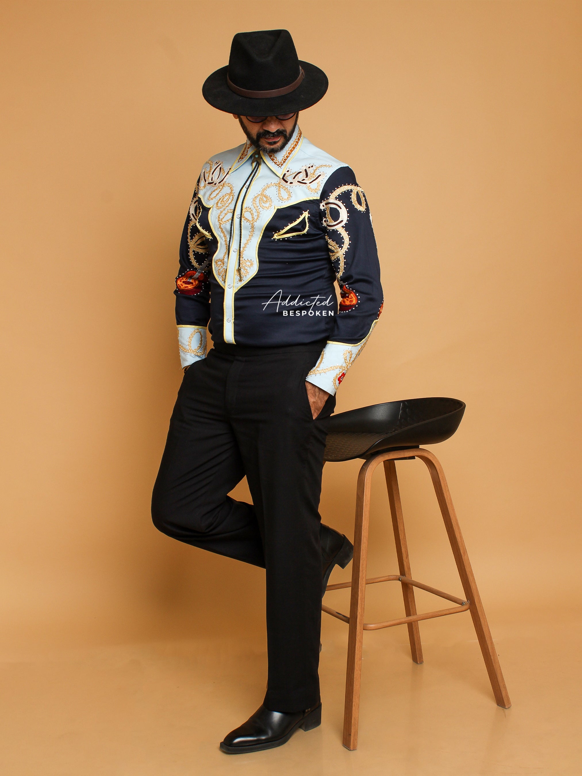 Standing side view of male model wearing black and cream embroidered western shirt – Addicted Bespoken