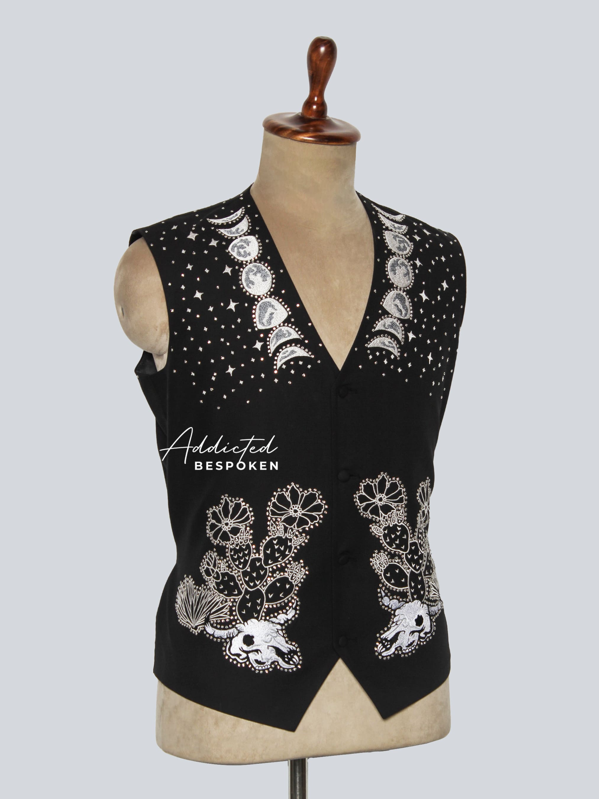 Black embellished vest on a mannequin with 'Addicted Bespoke' branding against a light gray background