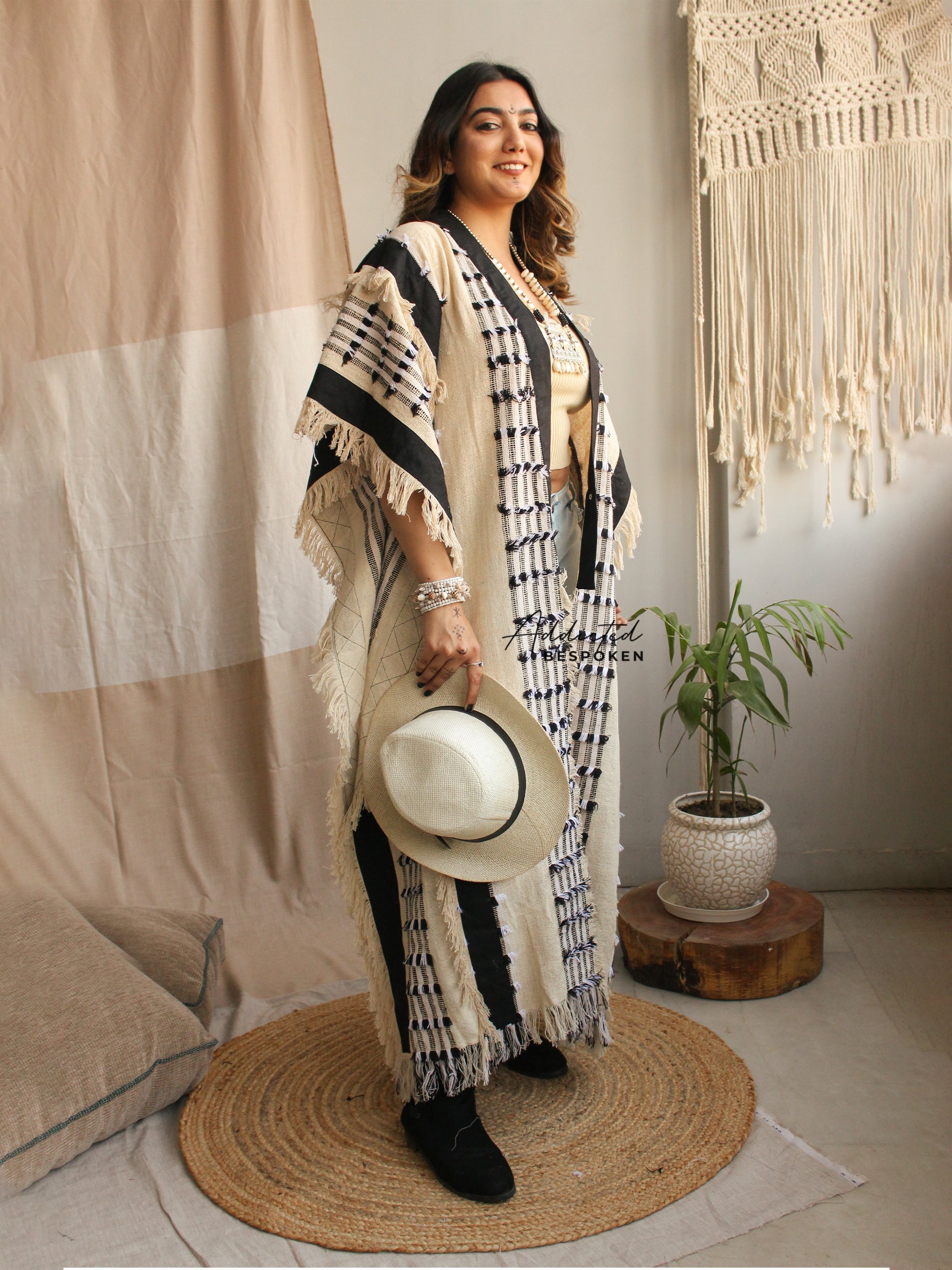Woman styling Nomadic Boho Cardigan Coat with wide hat – festival-ready boho clothing outfit